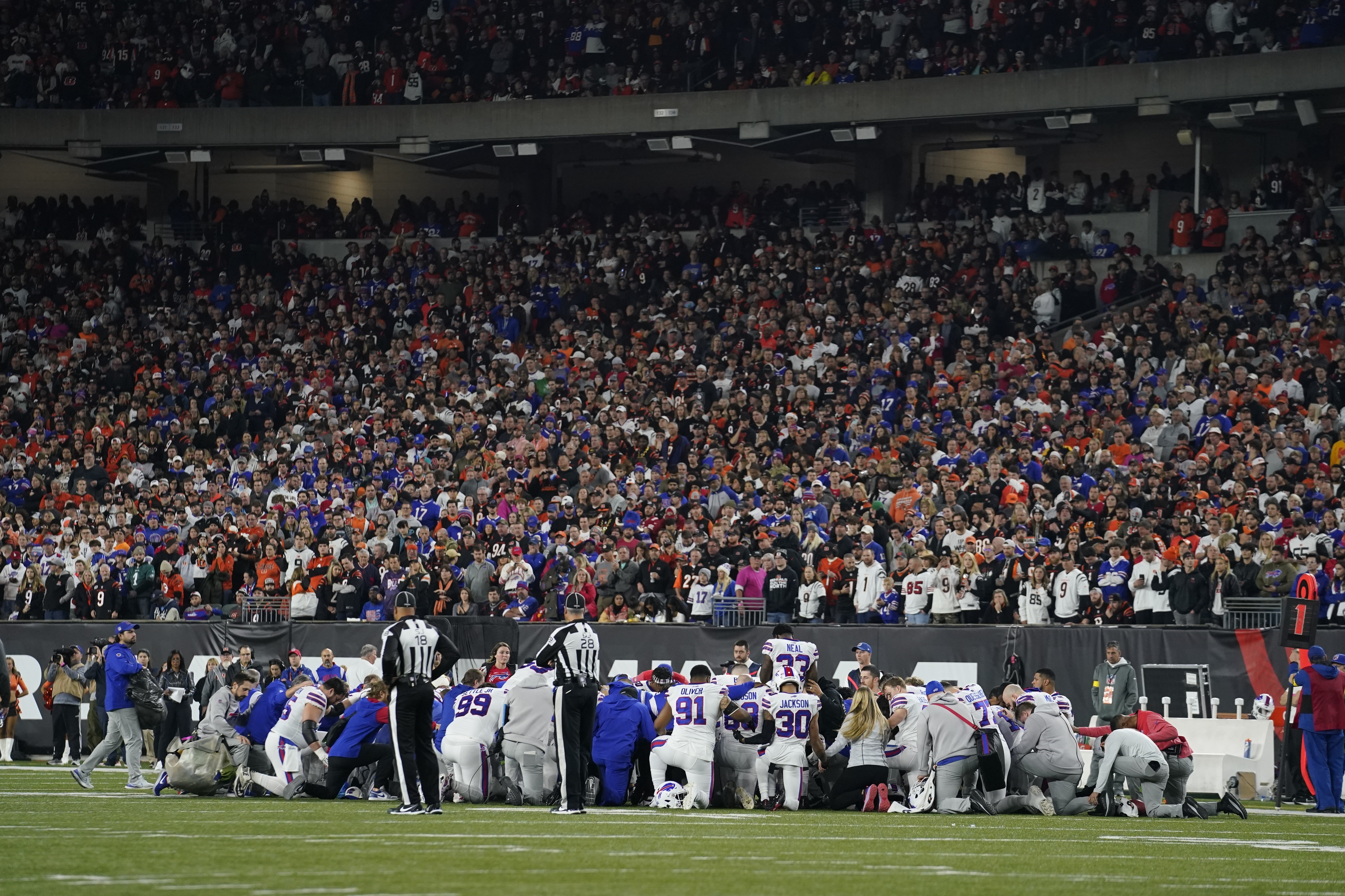 The Buffalo Bills players pray for teammate Damar Hamlin during the first half of an NFL football game against the Cincinnati Bengals Monday in Cincinnati.