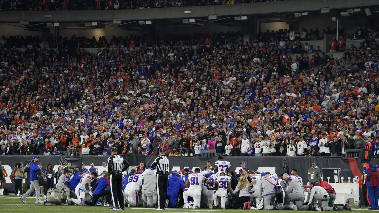 The Buffalo Bills players pray for teammate Damar Hamlin during the first half of an NFL football game against the Cincinnati Bengals Monday in Cincinnati.