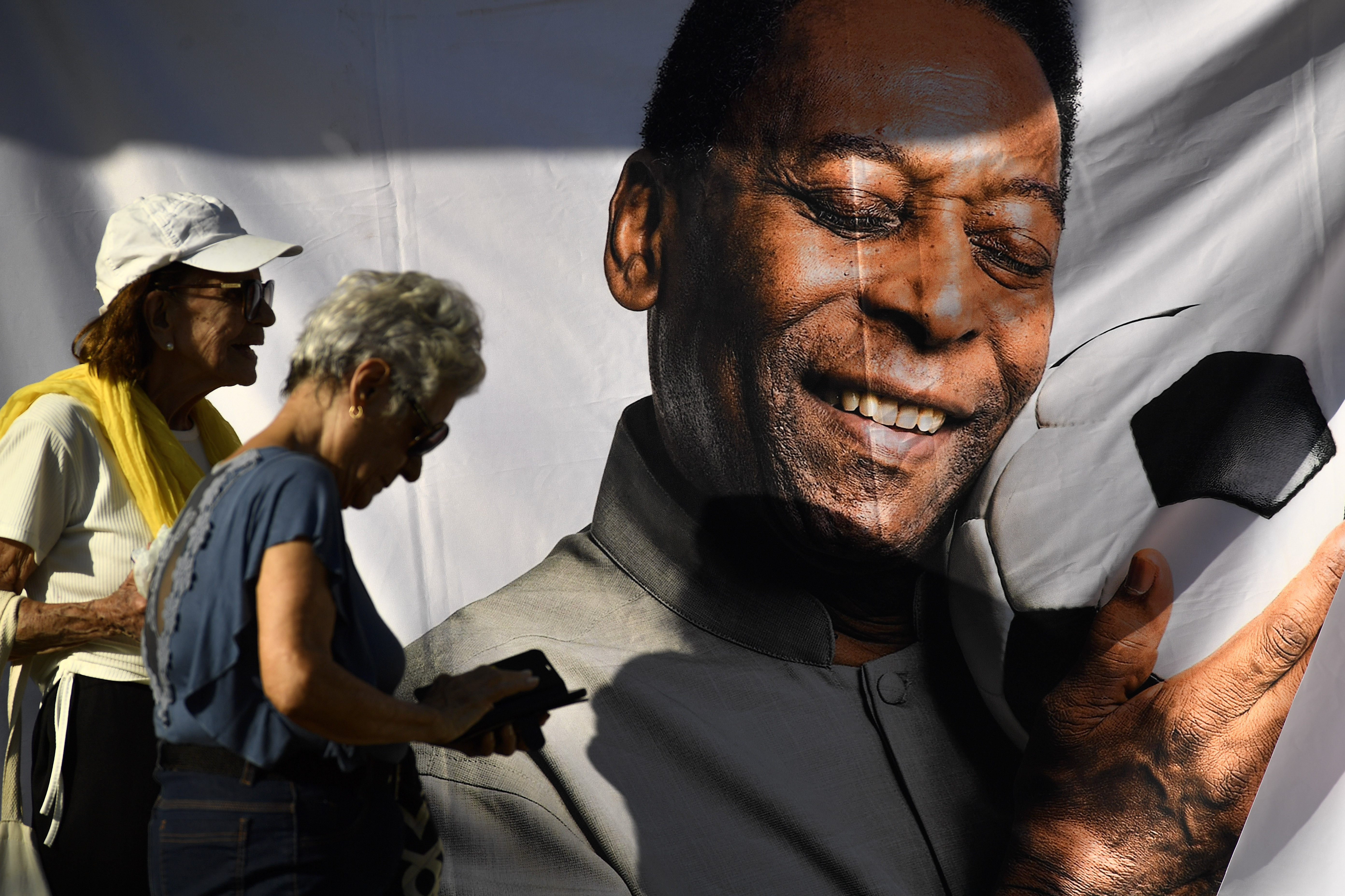 People wait in line to enter Vila Belmiro stadium where Pele, the late Brazilian soccer great lies in state in Santos, Brazil, Monday, Jan. 2, 2023. 
