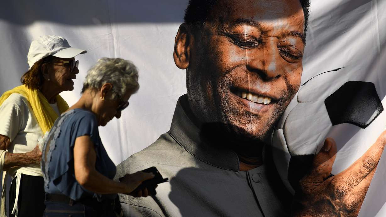 People wait in line to enter Vila Belmiro stadium where Pele, the late Brazilian soccer great lies in state in Santos, Brazil, Monday, Jan. 2, 2023.
