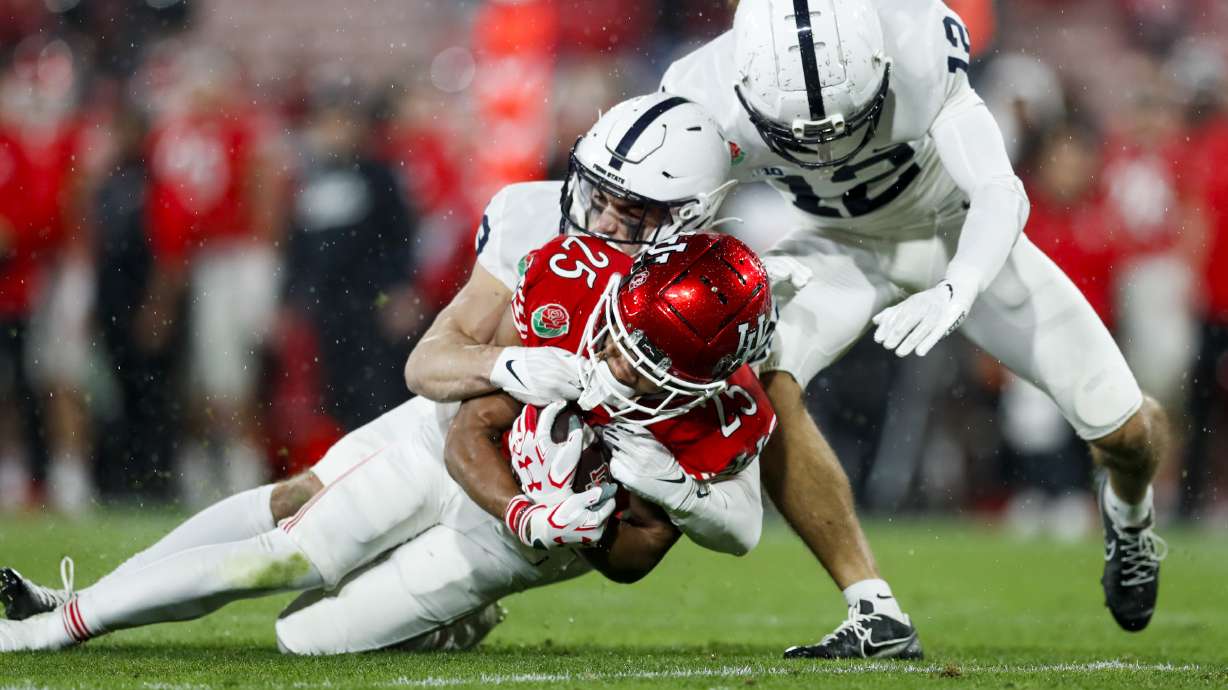 The Utah Utes' Jaylen Dixon (25) runs the ball for a first down and is tackled by Penn State Nittany Lions players during the 109th Rose Bowl in Pasadena on Monday, Jan. 2, 2023. The Penn State Nittany Lions won 35-21.