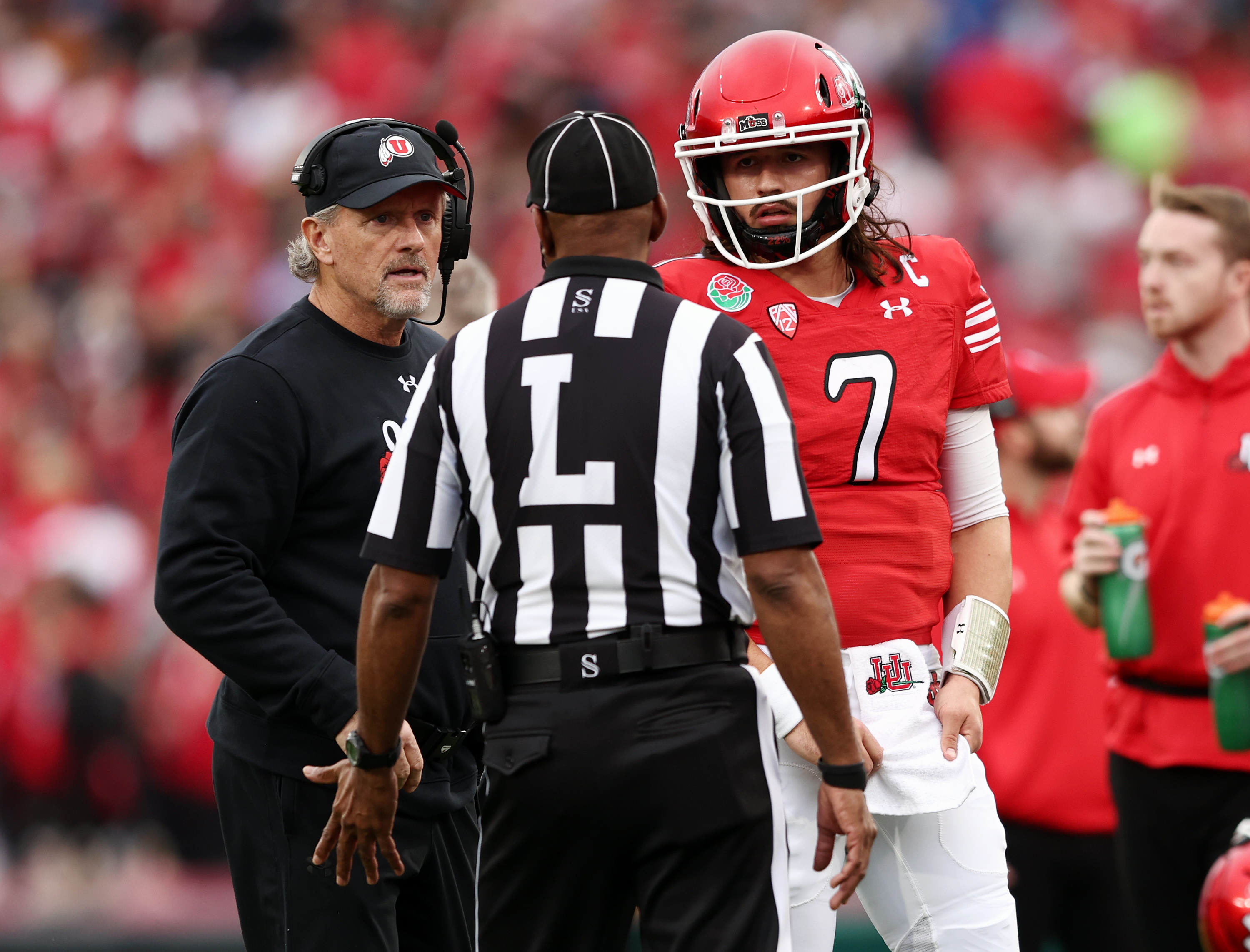 Utah Utes head coach Kyle Whittingham and Utah Utes QB Cameron Rising (7) listen to a official as Utah and Penn State play in the Rose Bowl in Pasadena, California, on Monday, Jan. 2, 2023.