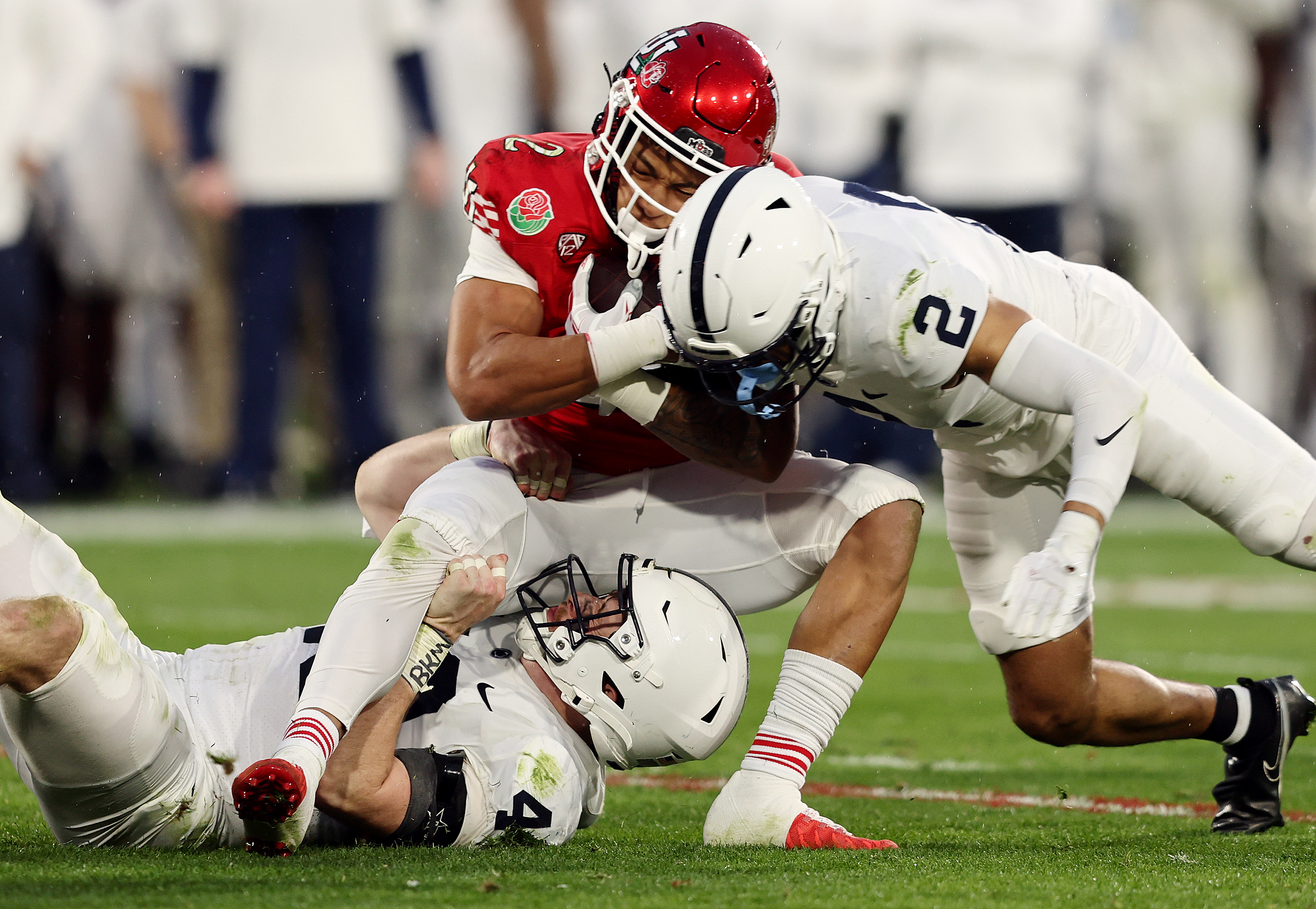 Utah Utes RB Micah Bernard (2) is hit and tackled by Penn State Nittany Lions LB Tyler Elsdon (43) and S Keaton Ellis (2) as Utah and Penn State play in the Rose Bowl in Pasadena, California, on Monday, Jan. 2, 2023. Penn State won 35-21.