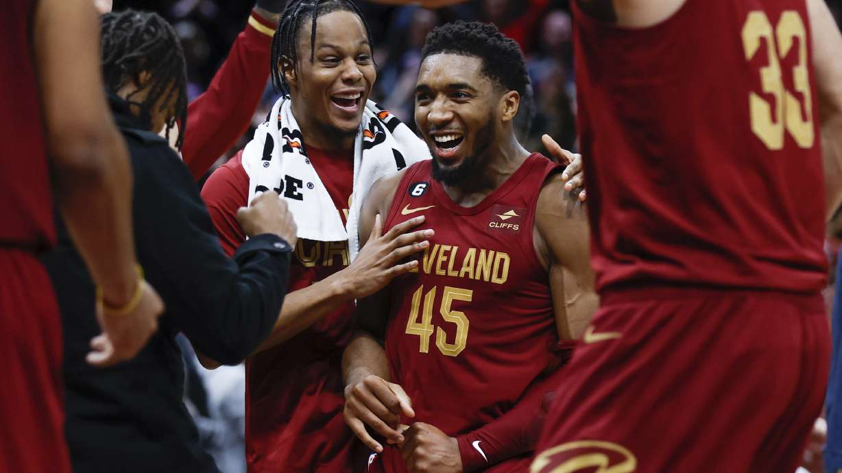 Cleveland Cavaliers guard Donovan Mitchell (45) celebrates with teammates after making a basket to tie an NBA basketball game during the second half against the Chicago Bulls, Monday, Jan. 2, 2023, in Cleveland.
