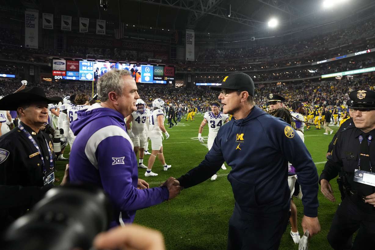 TCU head coach Sonny Dykes greets Michigan head coach Jim Harbaugh, right, after the Fiesta Bowl NCAA college football semifinal playoff game, Saturday, Dec. 31, 2022, in Glendale, Ariz.