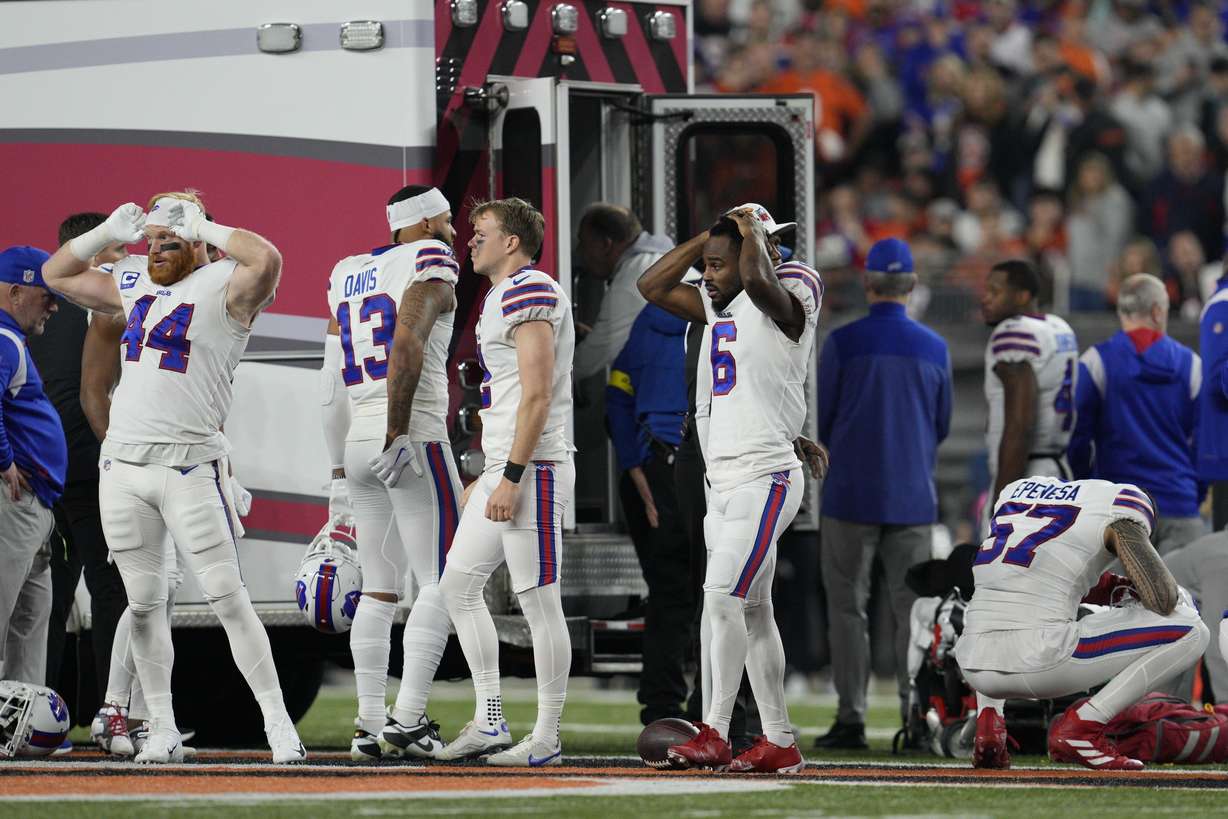 Buffalo Bills players react as teammate Damar Hamlin is examined during the first half of an NFL football game against the Cincinnati Bengals, Monday in Cincinnati.