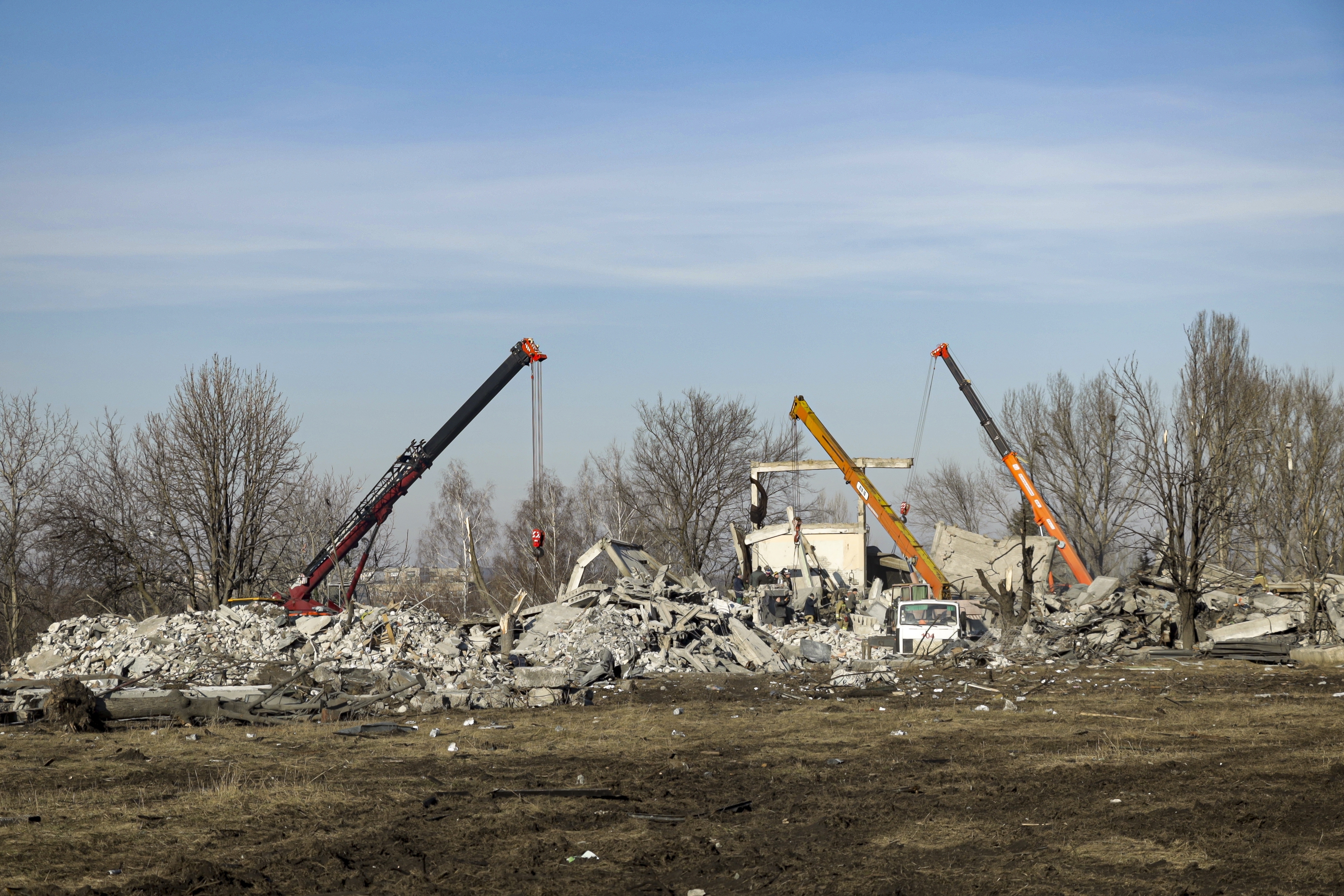 Workers clean rubbles after Ukrainian rocket strike in Makiivka, in Russian-controlled Donetsk region, eastern Ukraine, Tuesday. Russia's defense ministry says 63 of its soldiers have been killed by a Ukrainian strike on a facility in the eastern Donetsk region where military personnel were stationed.