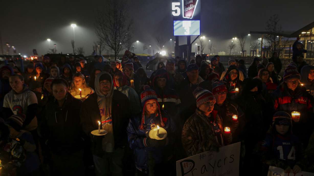 FILE - Buffalo Bills fans and community members gather for a candlelight vigil for Buffalo Bills safety Damar Hamlin on Tuesday, Jan. 3, 2023, in Orchard Park, N.Y. The Buffalo Bills have been a reliable bright spot for a city that has been shaken by a racist mass shooting and back-to-back snowstorms in recent months. So when Bills safety Damar Hamlin was critically hurt in a game Monday, the city quickly looked for ways to support the team.