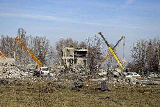 Workers clean rubbles after Ukrainian rocket strike in Makiivka, in Russian-controlled Donetsk region, eastern Ukraine, Tuesday. Russia's defense ministry says 63 of its soldiers have been killed by a Ukrainian strike on a facility in the eastern Donetsk region where military personnel were stationed.