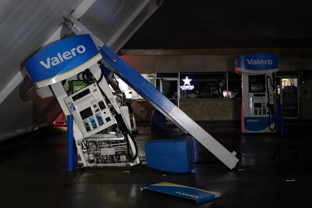 The canopy of a gas station, toppled by strong winds, rests at an angle, Wednesday, in South San Francisco. Another winter storm moved into California on Wednesday, walloping the northern part of the state with more rain and snow. It's the second major storm of the week in the parched state.