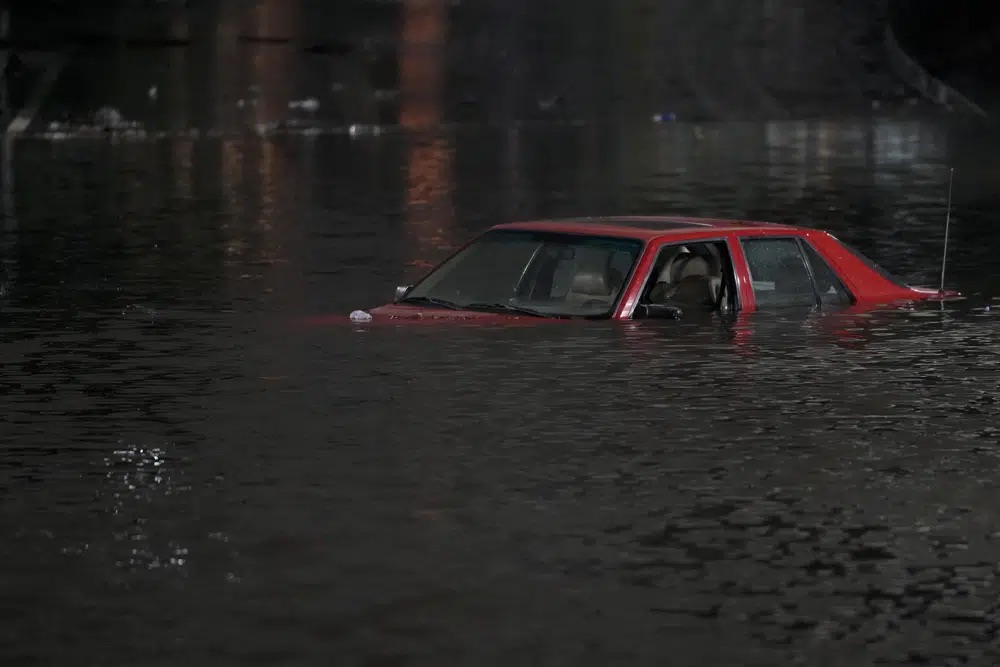 An empty vehicle is surrounded by floodwaters on a road in Oakland, Calif., Wednesday.