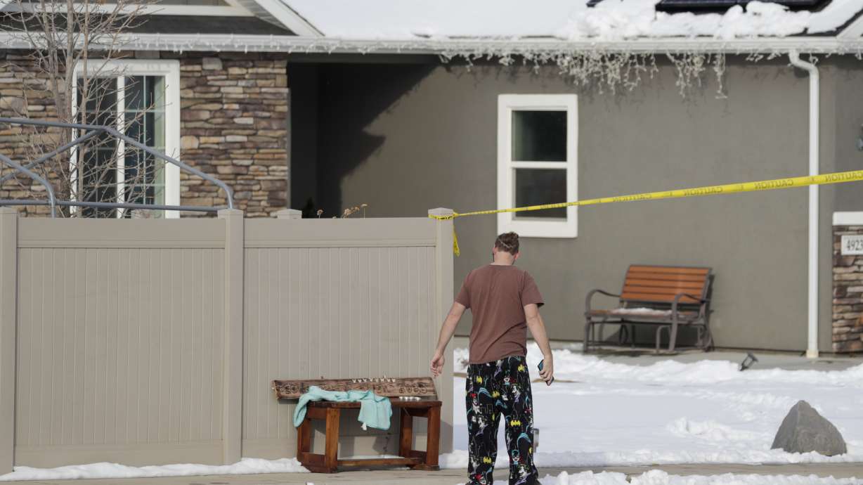A neighbor puts a bench in front of the house where eight members of a family were killed in Enoch, Iron County. New court documents say a daughter sent a text to a friend the day before they were found saying her father was acting strange.