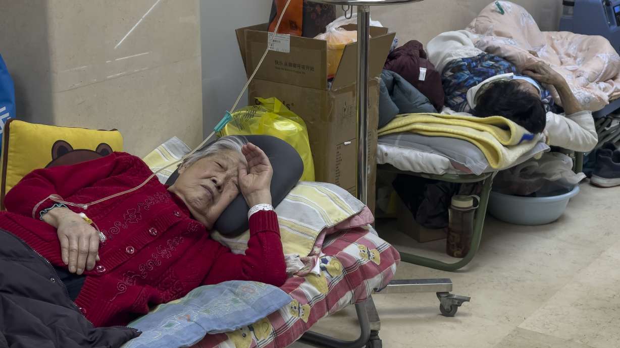 Elderly patients rest along a corridor of the emergency ward as they receive intravenous drips in Beijing, Thursday. Patients, most of them elderly, are lying on stretchers in hallways and taking oxygen while sitting in wheelchairs as COVID-19 surges in China’s capital Beijing.