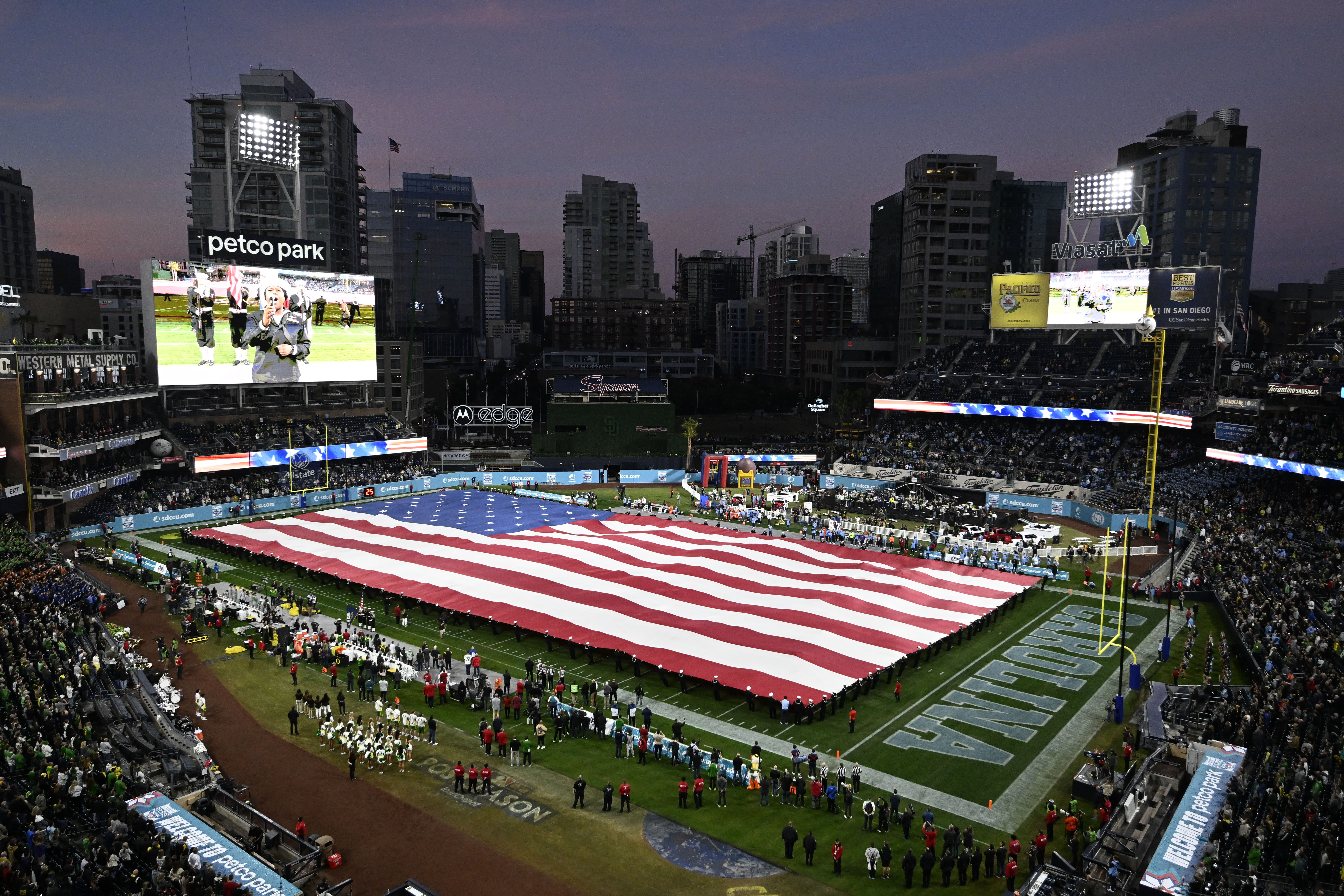 A U.S flag is rolled out onto the field before the Holiday Bowl NCAA college football game between North Carolina and Oregon Wednesday, Dec. 28, 2022, in San Diego. 