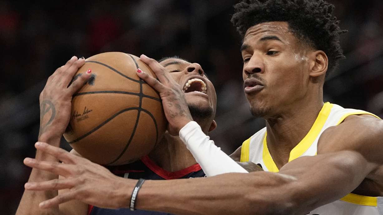 Houston Rockets' Jalen Green, left, is fouled by Utah Jazz's Ochai Agbaji (30) during the first half of an NBA basketball game Thursday, Jan. 5, 2023, in Houston.