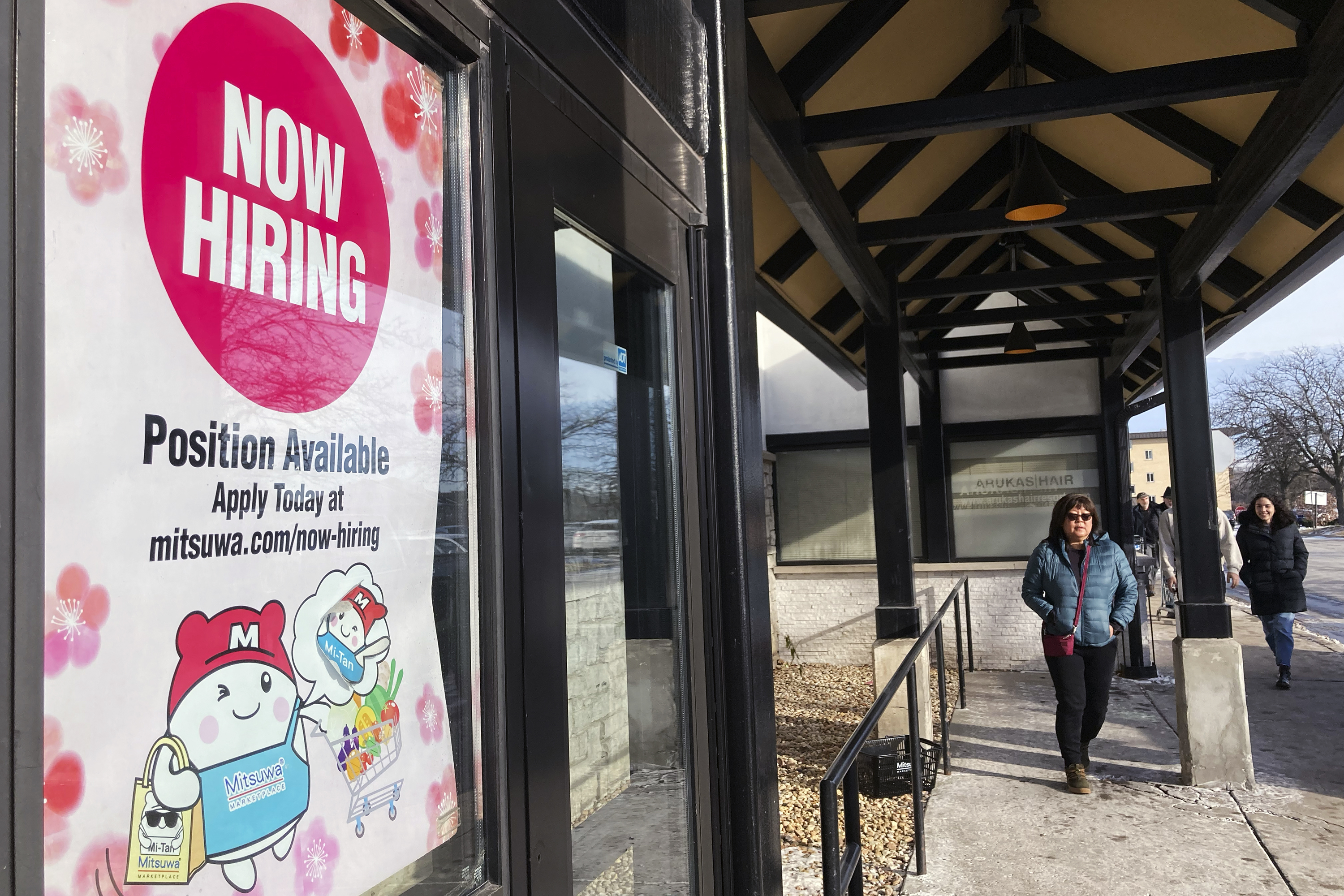 A hiring sign is displayed at a grocery store in Arlington Heights, Ill., Dec. 27, 2022. On Friday, the U.S. government said America's employers added a solid 223,000 jobs in December.