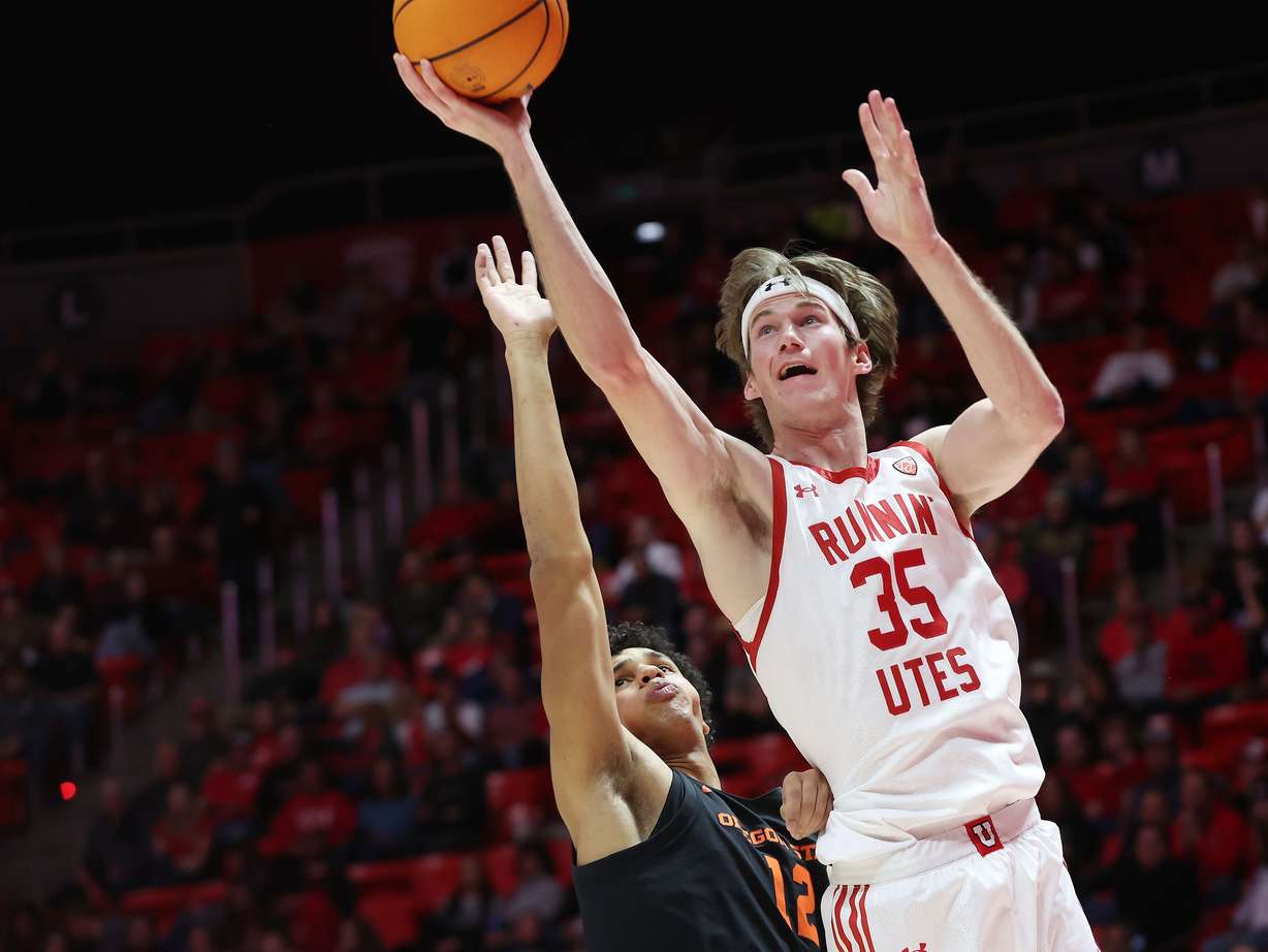 Utah Utes center Branden Carlson (35) drives on Oregon State Beavers forward Michael Rataj (12) in Salt Lake City on Thursday, Jan. 5, 2023. Utah won 79-60.