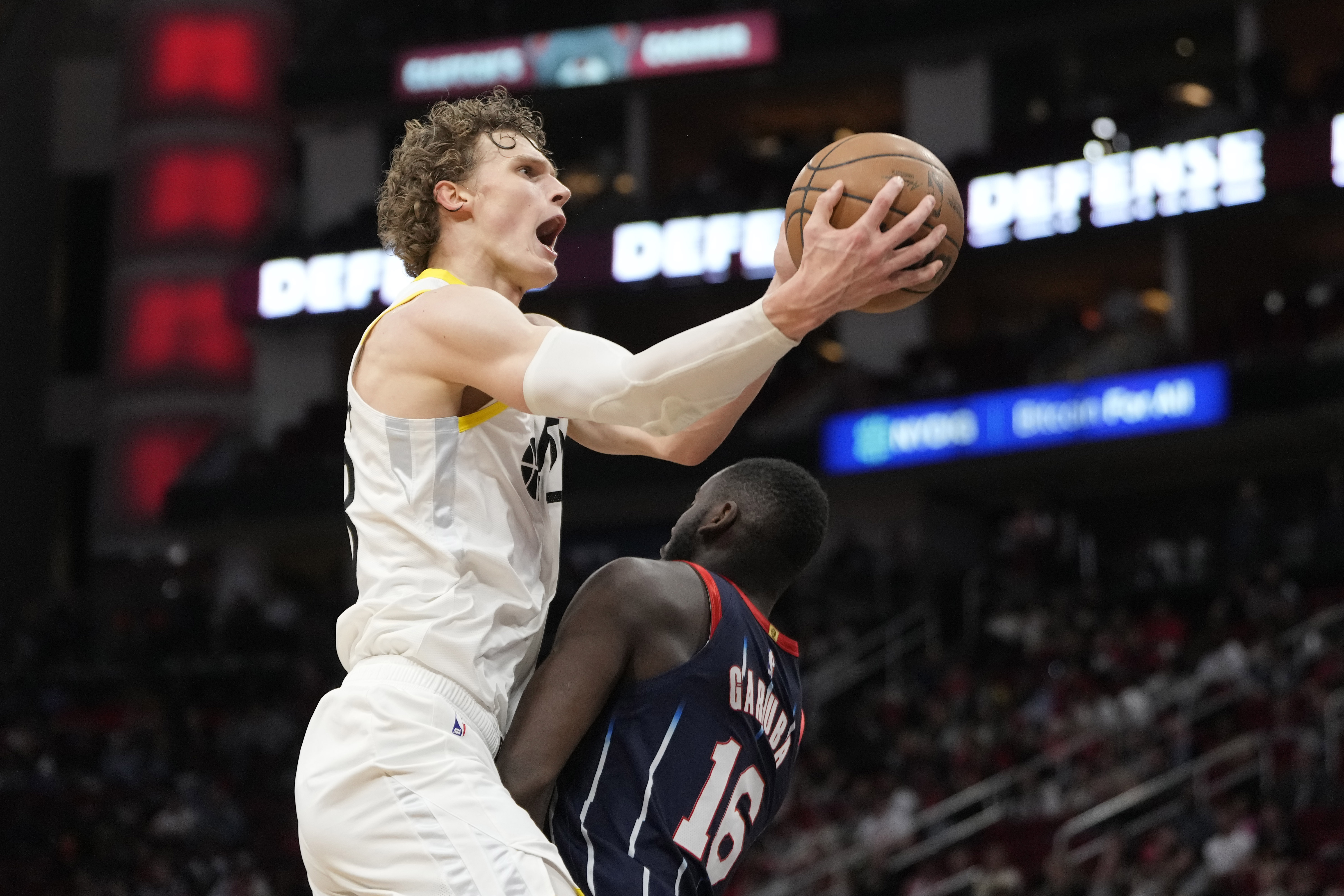 Utah Jazz's Lauri Markkanen, left, goes up for a shot as Houston Rockets' Usman Garuba (16) defends during the second half of an NBA basketball game Thursday, Jan. 5, 2023, in Houston. The Jazz won 131-114.