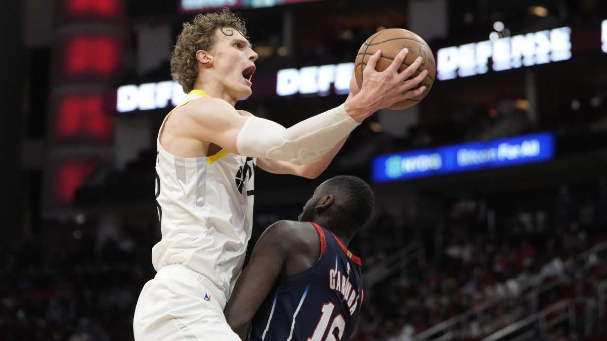 Utah Jazz's Lauri Markkanen, left, goes up for a shot as Houston Rockets' Usman Garuba (16) defends during the second half of an NBA basketball game Thursday, Jan. 5, 2023, in Houston. The Jazz won 131-114.