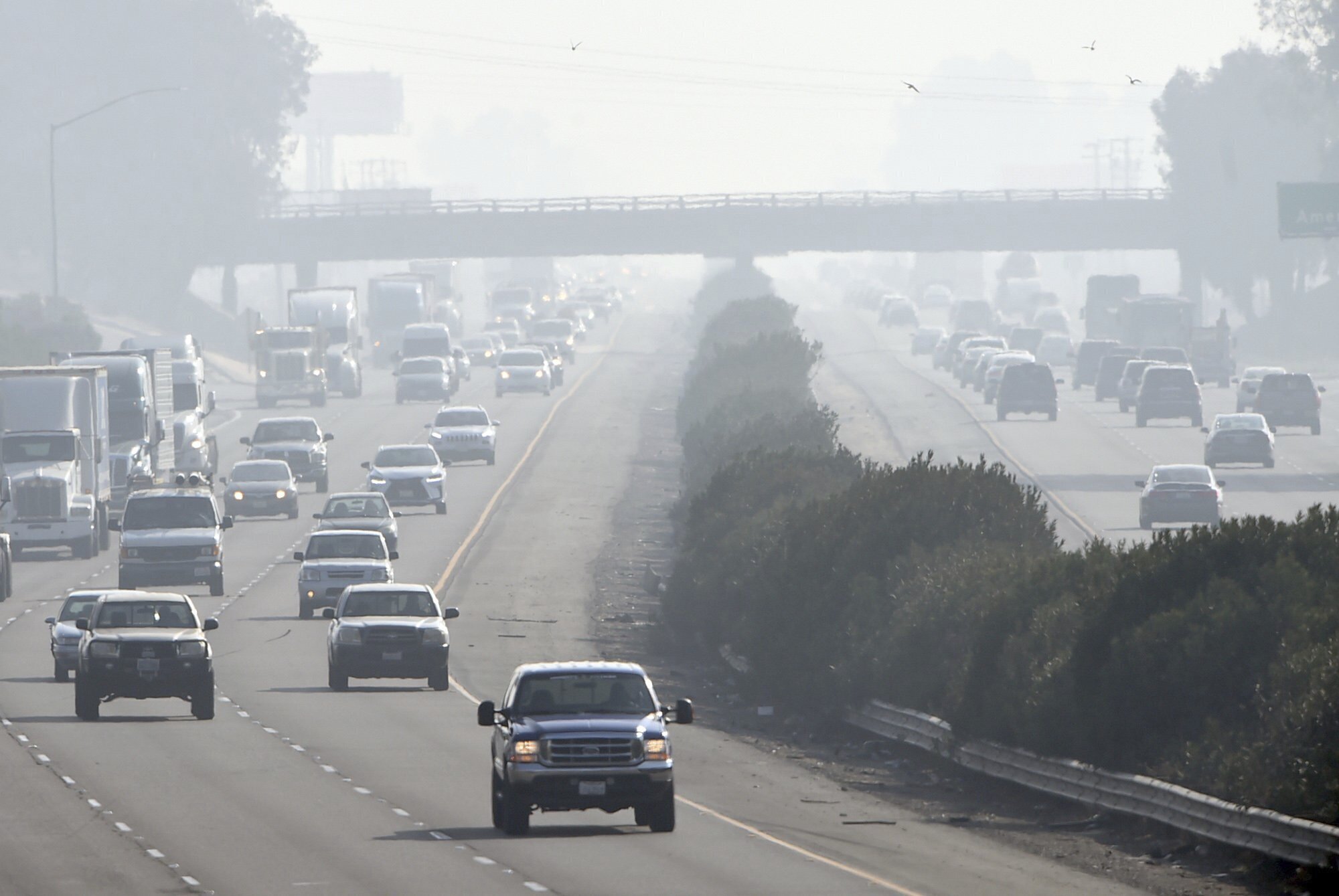 Traffic moves along along Highway 99 south in Fresno, Calif., Dec. 28, 2017. The Environmental Protection Agency says tougher standards for soot from tailpipes, smokestacks and wildfires could prevent thousands of premature deaths a year.