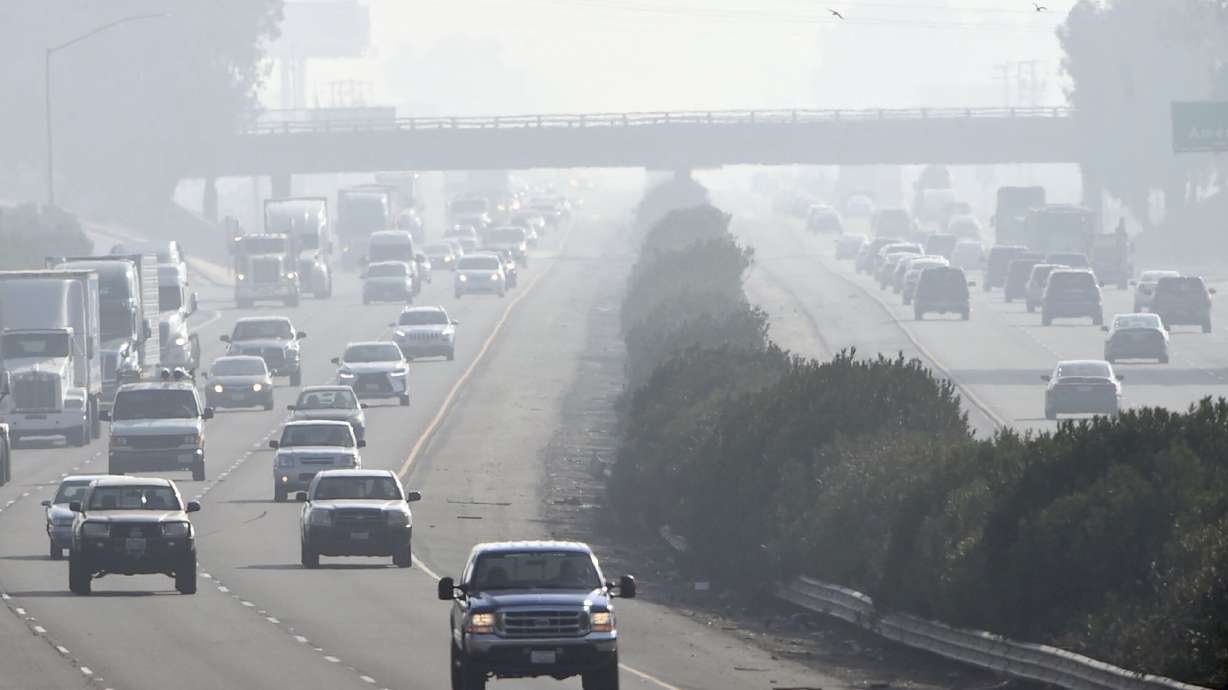 Traffic moves along along Highway 99 south in Fresno, Calif., Dec. 28, 2017. The Environmental Protection Agency says tougher standards for soot from tailpipes, smokestacks and wildfires could prevent thousands of premature deaths a year.