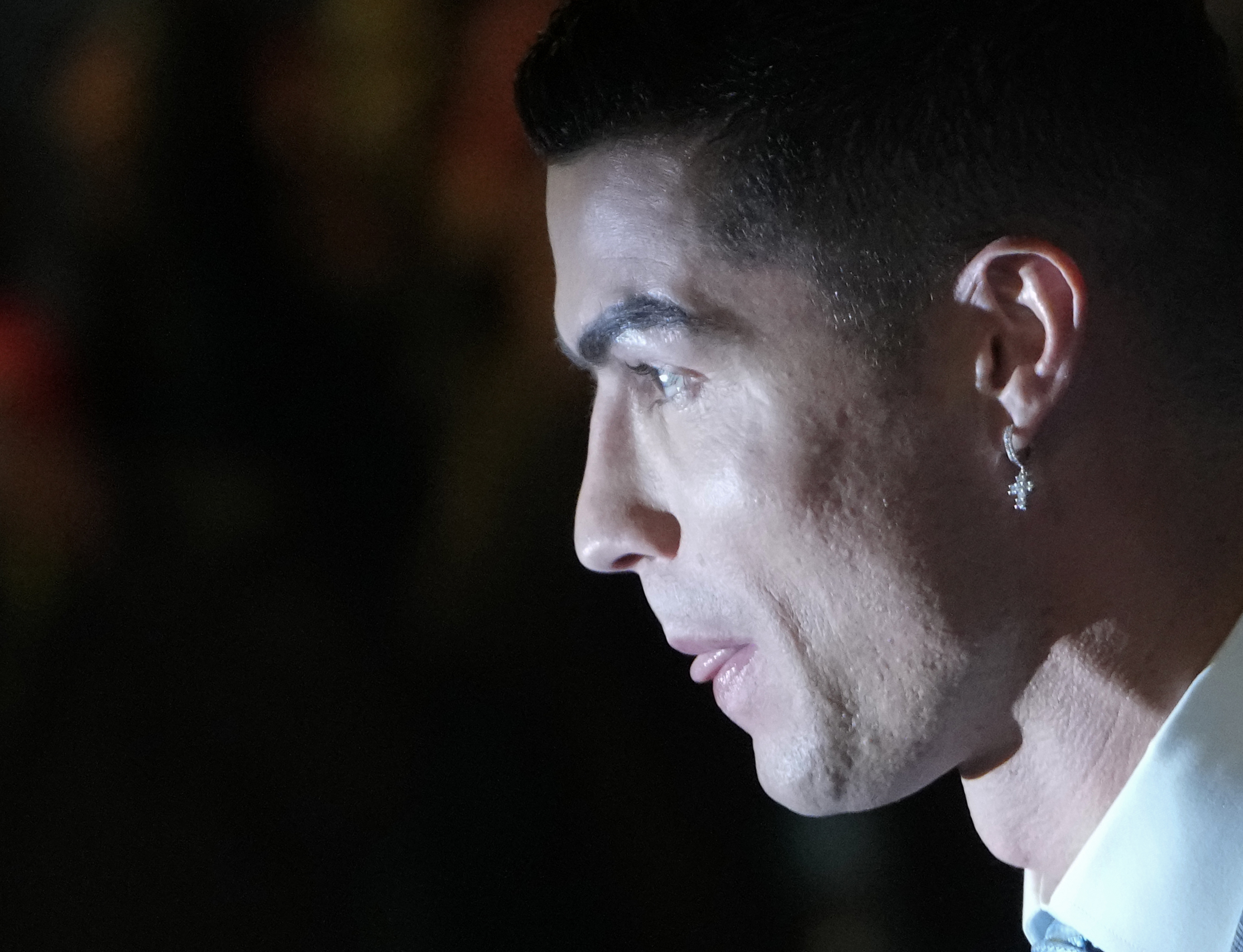 Cristiano Ronaldo wears an earring with a cross as he attends the official unveiling as a new member of Al Nassr soccer club in in Riyadh, Saudi Arabia, Tuesday, Jan. 3, 2023. Ronaldo, who has won five Ballon d'Ors awards for the best soccer player in the world and five Champions League titles, will play outside of Europe for the first time in his storied career. 