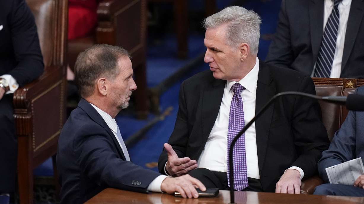 Rep. Chris Stewart, R-Utah, left, talks with Rep. Kevin McCarthy, R-Calif., in the House chamber as the House met for a second day to elect a speaker and convene the 118th Congress in Washington, Wednesday. Late Friday night, McCarthy was elected speaker.