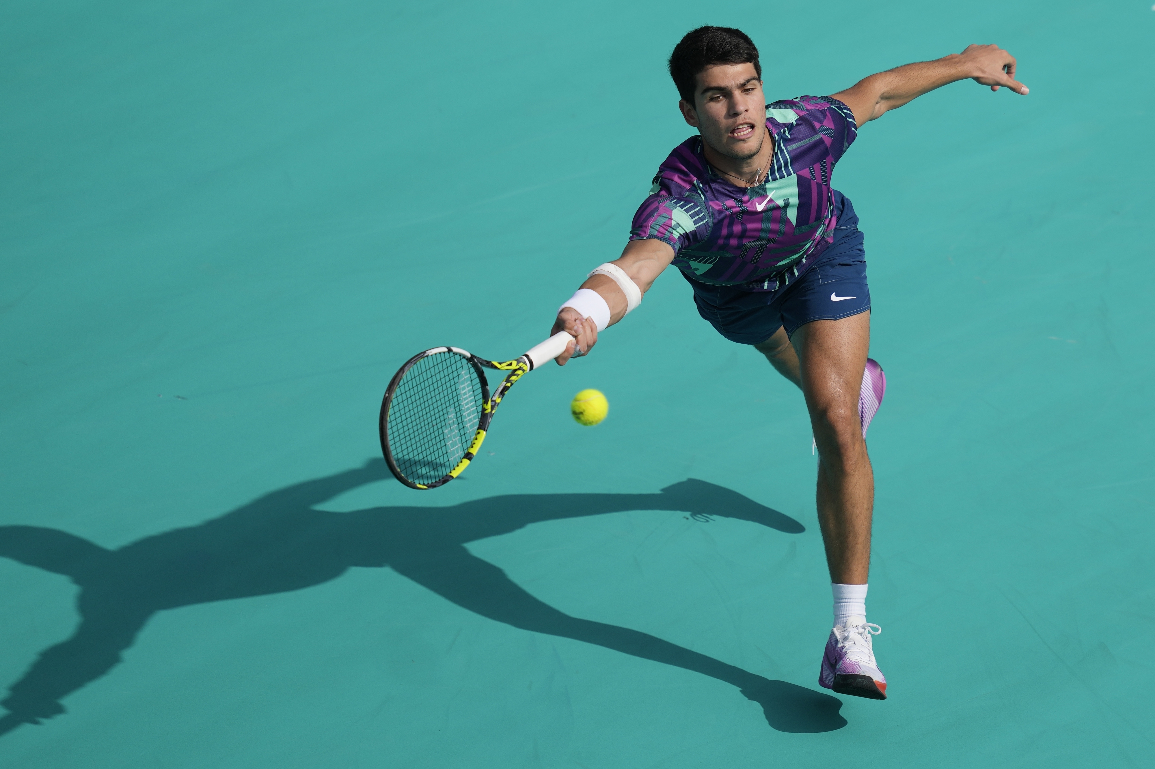 Carlos Alcaraz of Spain Casper returns the ball to Ruud of Norway, during a match for the third place of the Mubadala World Tennis Championship, in Abu Dhabi, United Arab Emirates, Sunday, Dec. 18, 2022.