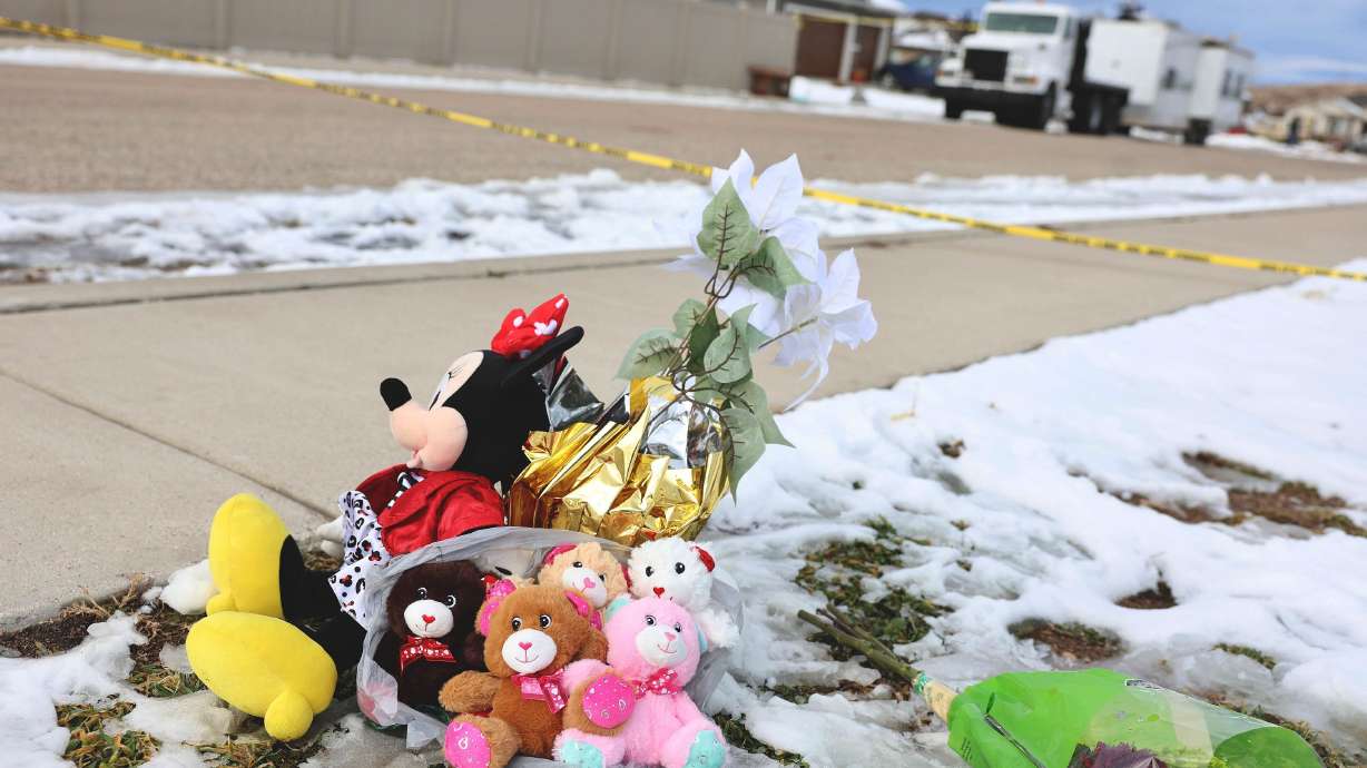 Five stuffed animals left by the the Enoch Elementary School PTA are pictured at a makeshift memorial near the police tape at a home where eight members of a family were killed in Enoch, Iron County, on Thursday.