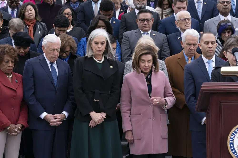 Incoming House Minority Leader Hakeem Jeffries, D-N.Y., accompanied by from left, Rep. Maxine Waters, D-Calif., Rep. Steny Hoyer, D-Md., incoming House Minority Whip Rep. Katherine Clark, D-Mass., Rep. Nancy Pelosi, D-Calif., along with members of Congress and family of fallen officers, pauses for a moment of silence during a ceremony marking the second year anniversary of the violent insurrection by supporters of then-President Donald Trump, in Washington, Friday.