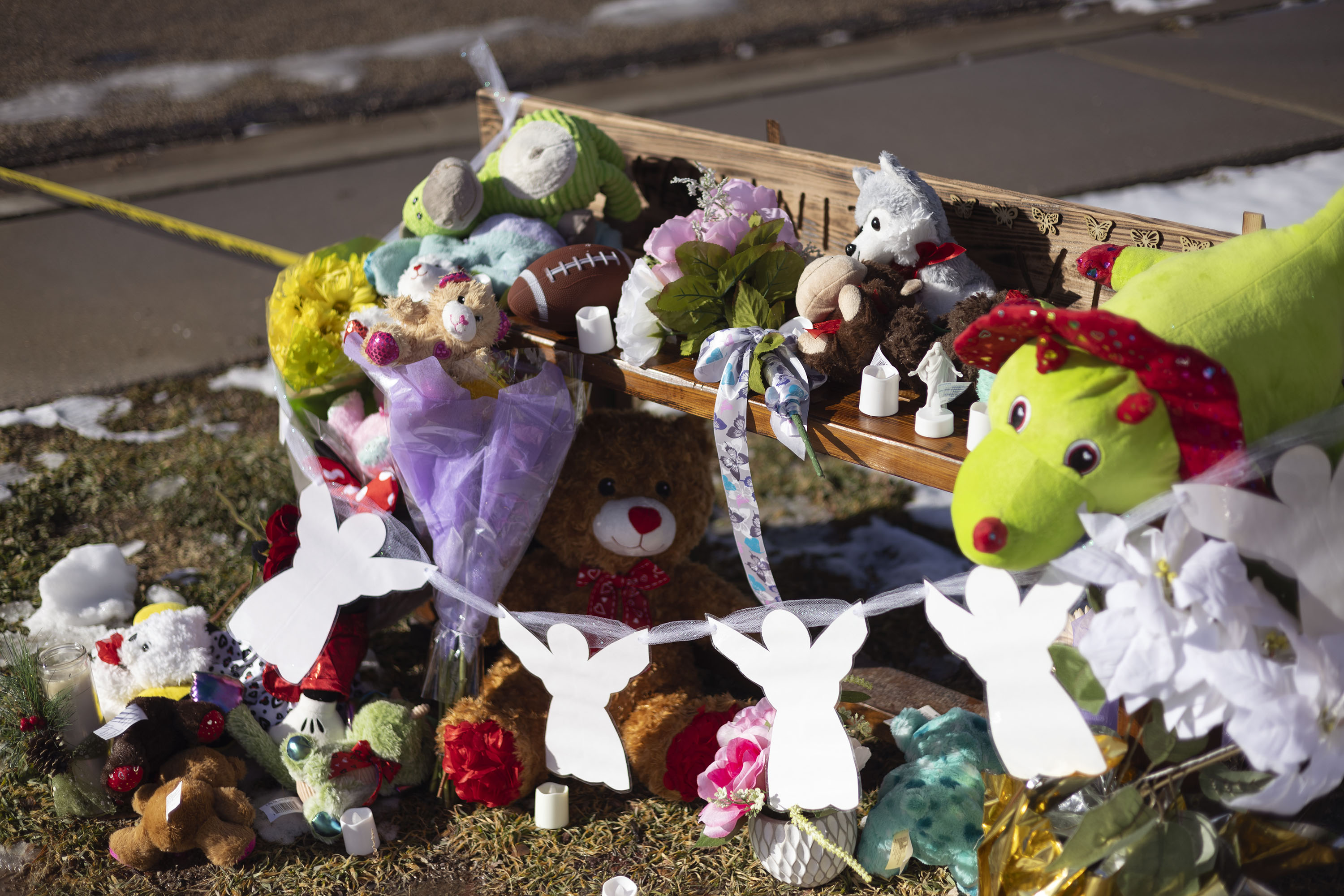 A memorial is pictured across the street from the Haight home in Enoch, Iron County, on Friday. An online fundraiser has been set up for the seven members of the family who police say were shot and killed by the children's father.