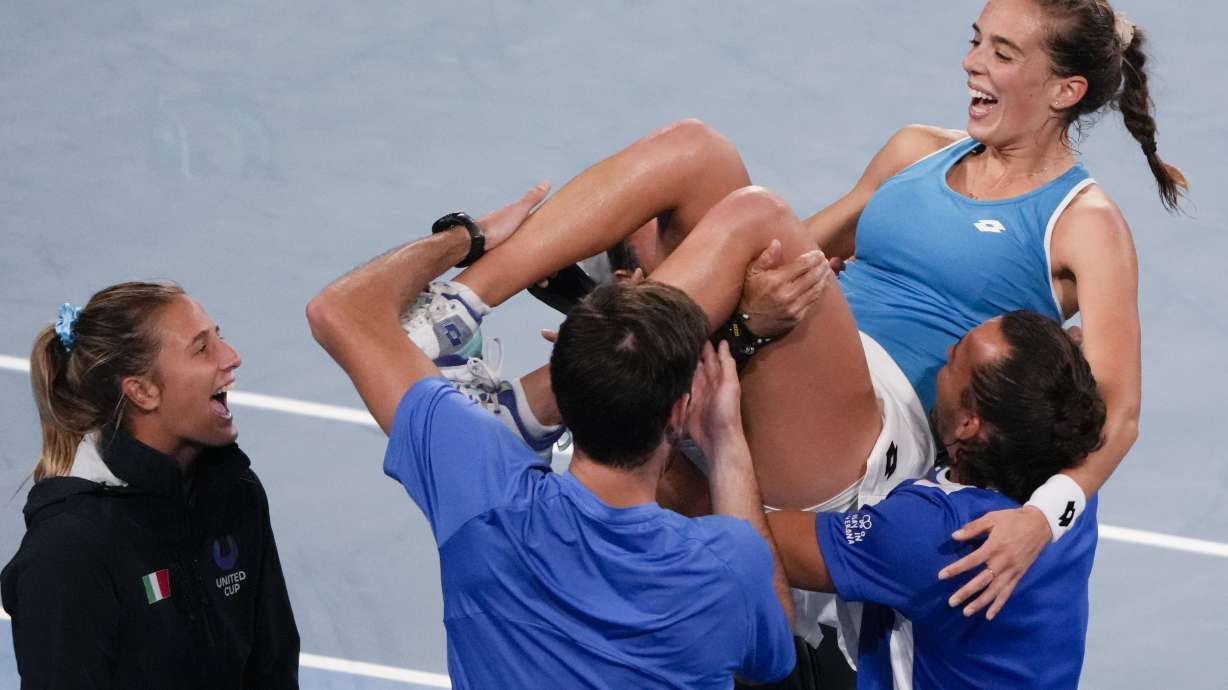 Italy's Lucia Bronzetti, centre, is held aloft by teammates after defeating Valentini Grammatikopoulou of Greece in their semifinal match at the United Cup tennis event in Sydney, Australia, Saturday, Jan. 7, 2023.