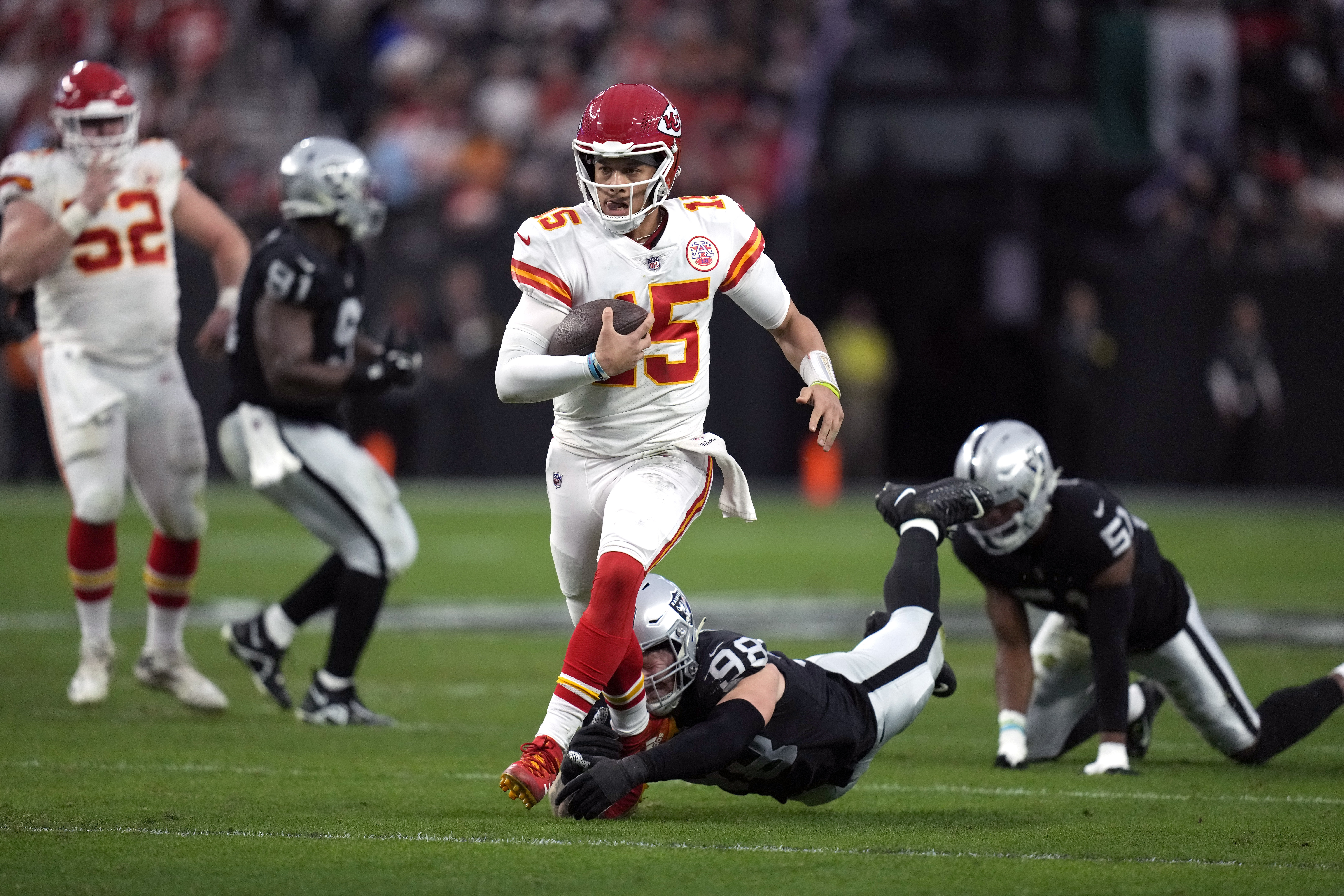 Kansas City Chiefs quarterback Patrick Mahomes runs with the ball against the Las Vegas Raiders during the first half of an NFL football game Saturday, Jan. 7, 2023, in Las Vegas. 