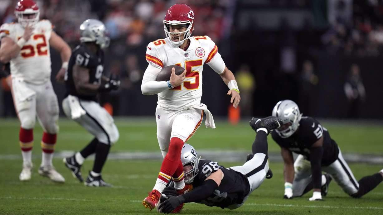 Kansas City Chiefs quarterback Patrick Mahomes runs with the ball against the Las Vegas Raiders during the first half of an NFL football game Saturday, Jan. 7, 2023, in Las Vegas.