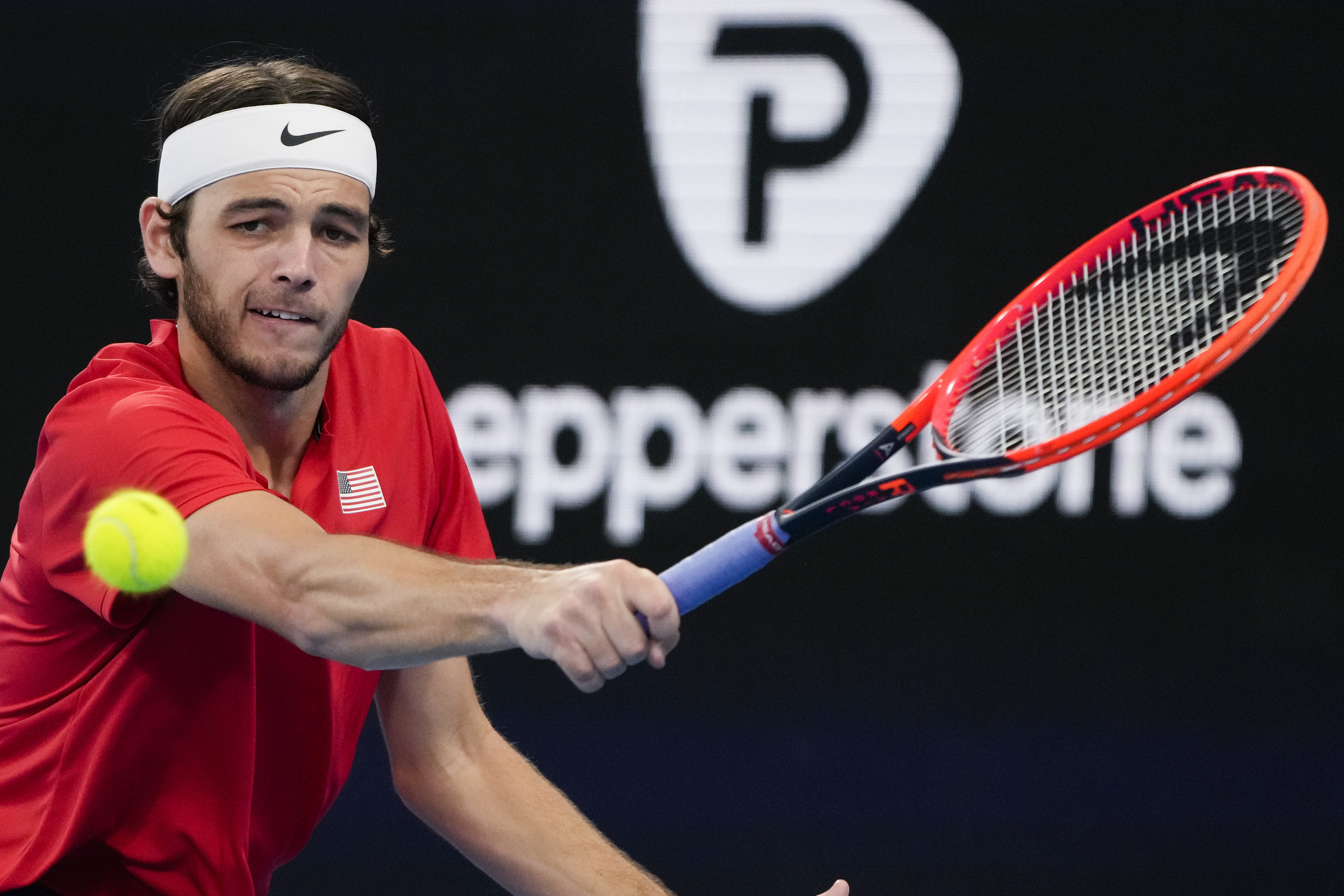 United States' Taylor Fritz plays a backhand return to Italy's Matteo Berrettini during the final of the United Cup tennis event in Sydney, Australia, Sunday, Jan. 8, 2023. 