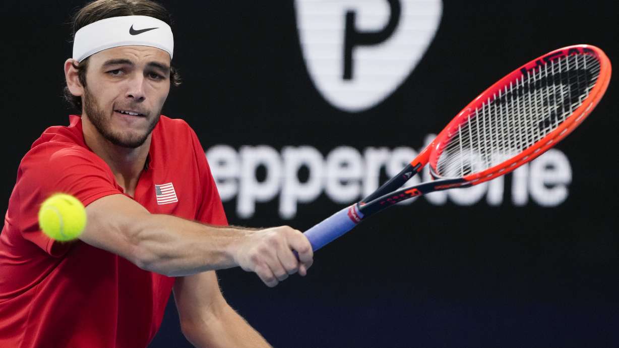 United States' Taylor Fritz plays a backhand return to Italy's Matteo Berrettini during the final of the United Cup tennis event in Sydney, Australia, Sunday, Jan. 8, 2023.