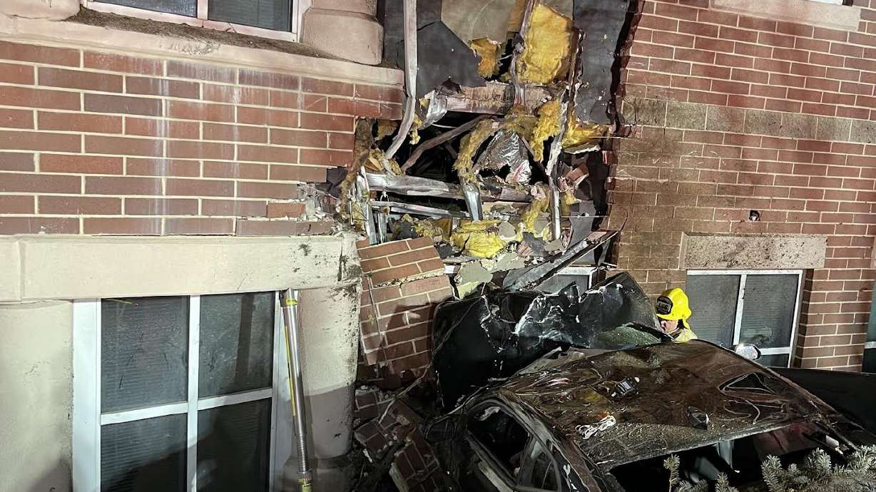 Two people died and another was injured after their vehicle struck a building early Sunday.