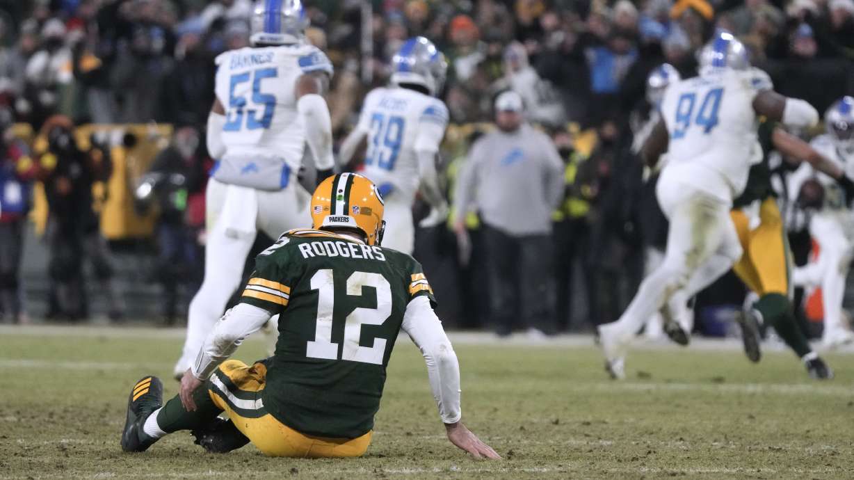 Green Bay Packers quarterback Aaron Rodgers sits on the turf after throwing an interception during the second half of an NFL football game against the Detroit Lions Sunday, Jan. 8, 2023, in Green Bay, Wis.
