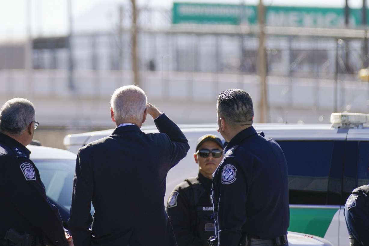President Joe Biden, second from left, looks towards a large "Welcome to Mexico" sign that is hung over the Bridge of the Americas as he tours the El Paso port of entry, a busy port of entry along the U.S.-Mexico border, in El Paso Texas, Sunday.