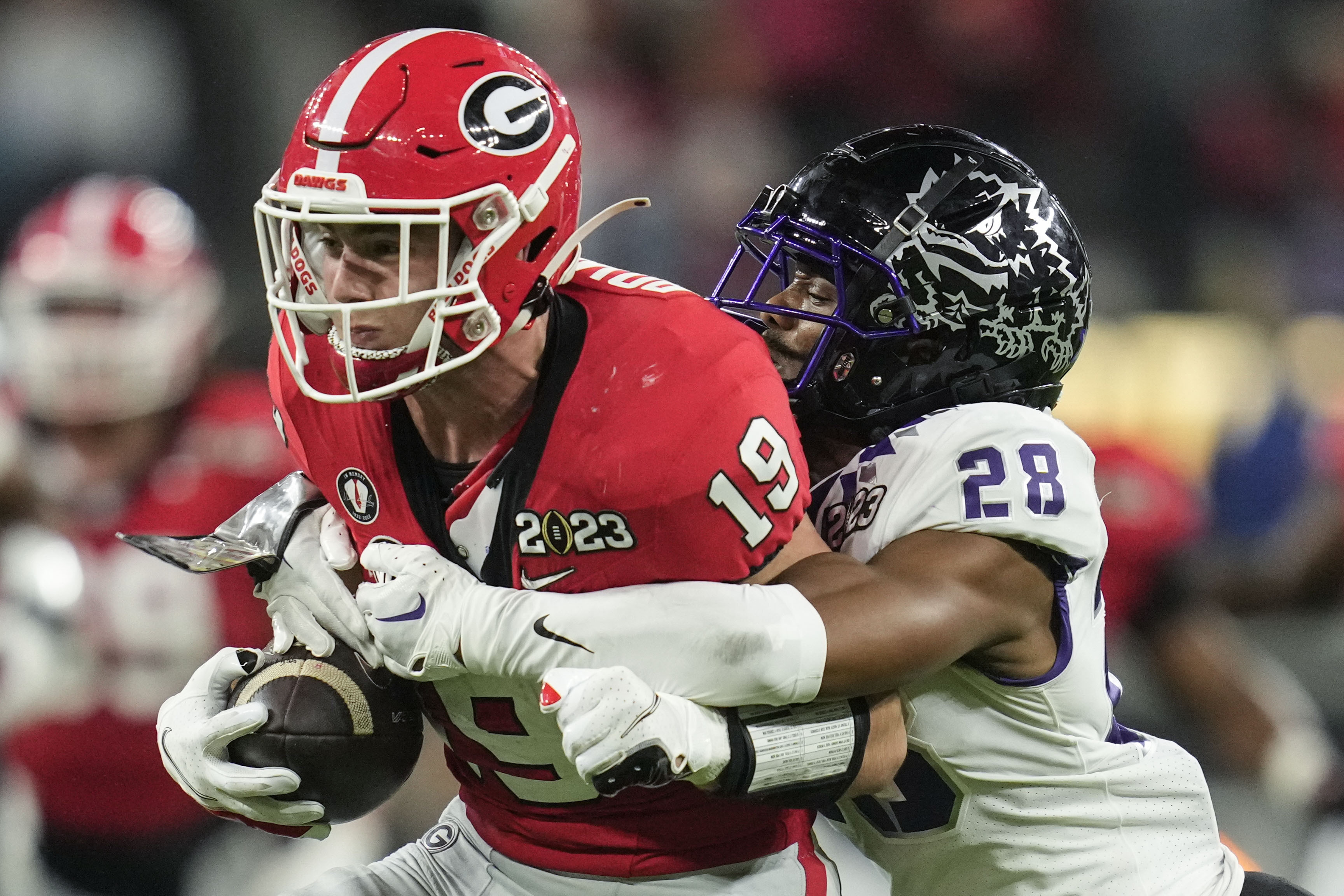 TCU safety Millard Bradford (28) tackles Georgia tight end Brock Bowers (19) during the first half of the national championship NCAA College Football Playoff game, Monday, Jan. 9, 2023, in Inglewood, Calif. 