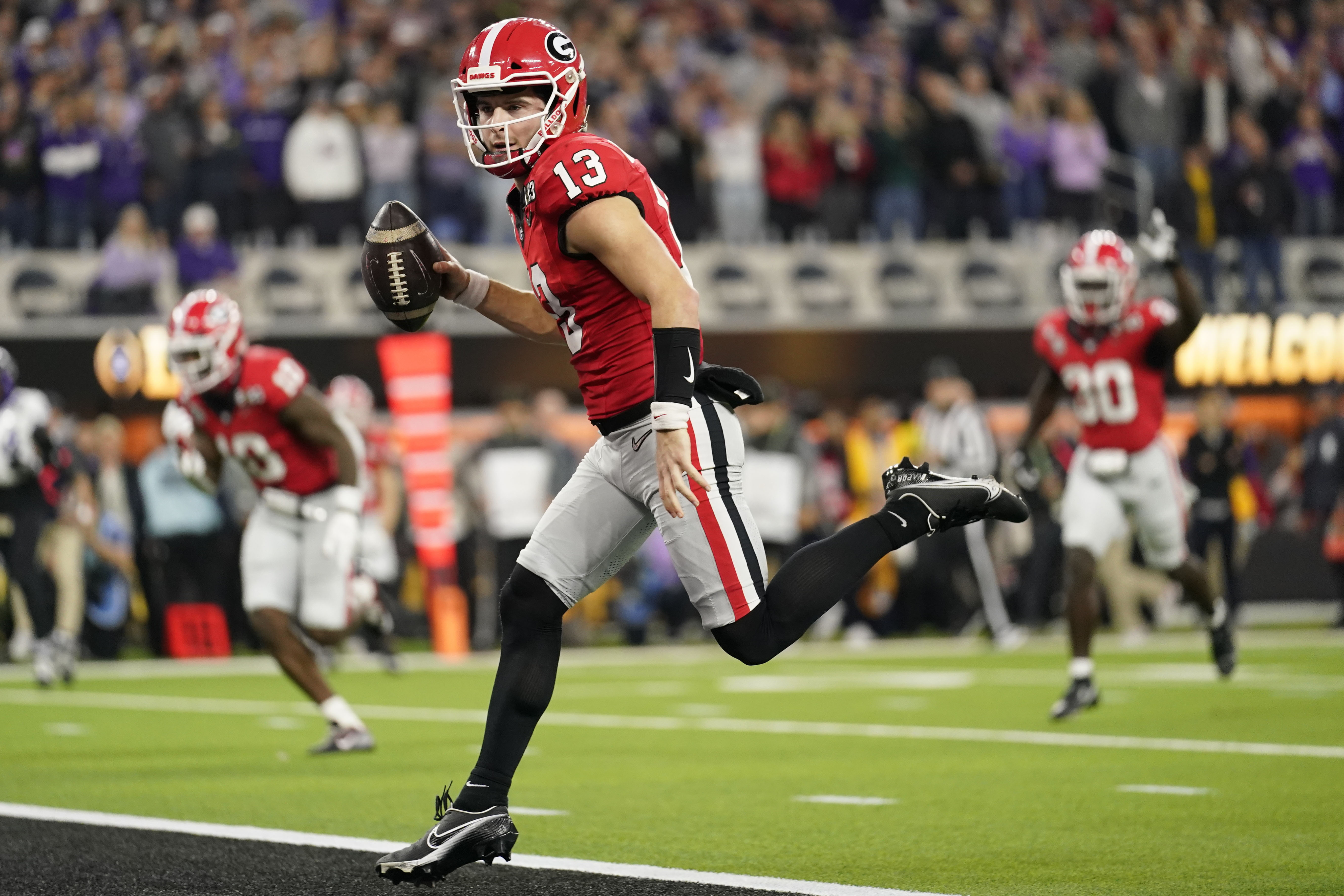 Georgia quarterback Stetson Bennett (13) runs into the end zone for a touchdown against TCU during the first half of the national championship NCAA College Football Playoff game, Monday, Jan. 9, 2023, in Inglewood, Calif. 