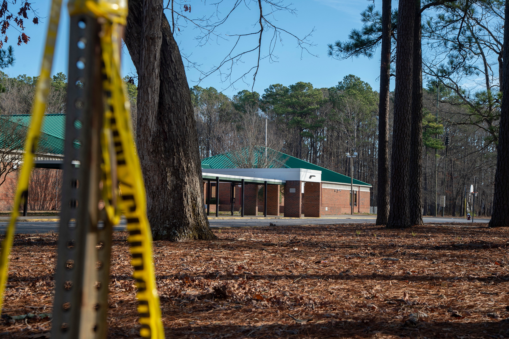 Police tape hangs from a sign post outside Richneck Elementary School following a shooting on Jan. 7, in Newport News, Va. The mother of a 6-year-old boy who authorities say shot his teacher at a Virginia elementary school could face charges, Newport News Police Chief Steve Drew said Tuesday.