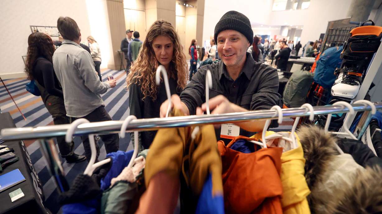 Frankie Krempa, Well+Good commerce editor, looks at Outdoor Research jackets with Chris Dickerson, Verde director of digital integration, during the Outdoor Retailer media preview at the Hyatt Regency Salt Lake in Salt Lake City on Monday.