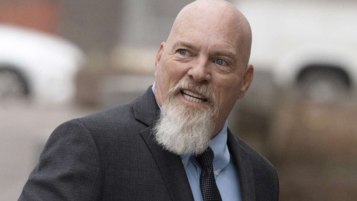 Richard Barnett, left, an Arkansas man who was photographed with his feet on a desk in former House Speaker Nancy Pelosi's office during the Jan. 6 U.S. Capitol riot, arrives at federal court in Washington, Tuesday.