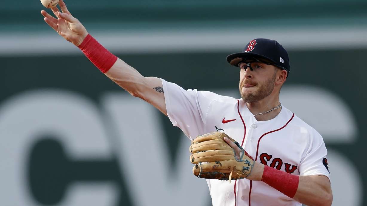 FILE - Boston Red Sox's Trevor Story throws to first base on the force out single by Texas Rangers' Marcus Semien during the third inning of a baseball game, Saturday, Sept. 3, 2022, in Boston. Red Sox infielder Trevor Story had surgery on his throwing elbow and appears likely to miss a significant portion of the 2023 season. Boston said Tuesday, Jan. 10, 2023, that Story underwent an internal bracing procedure on his right ulnar collateral ligament a day earlier. Texas Rangers team physician Dr. Keith Meister operated at Texas Metroplex Institute in Arlington, Texas.