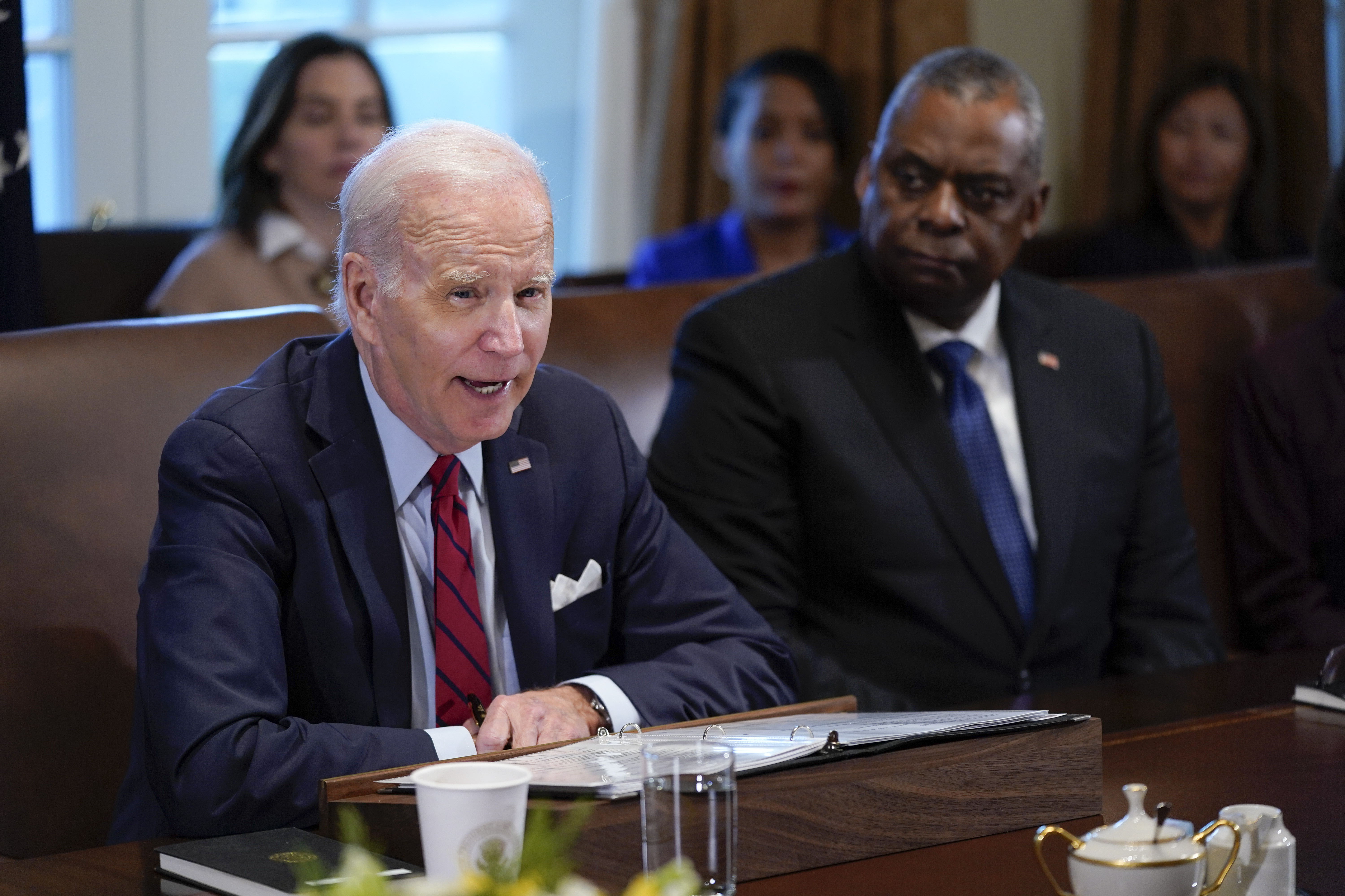 President Joe Biden speaks Thursday at the White House. Secretary of Defense Lloyd Austin listens at right. The Pentagon has formally dropped its COVID-19 vaccination mandate.