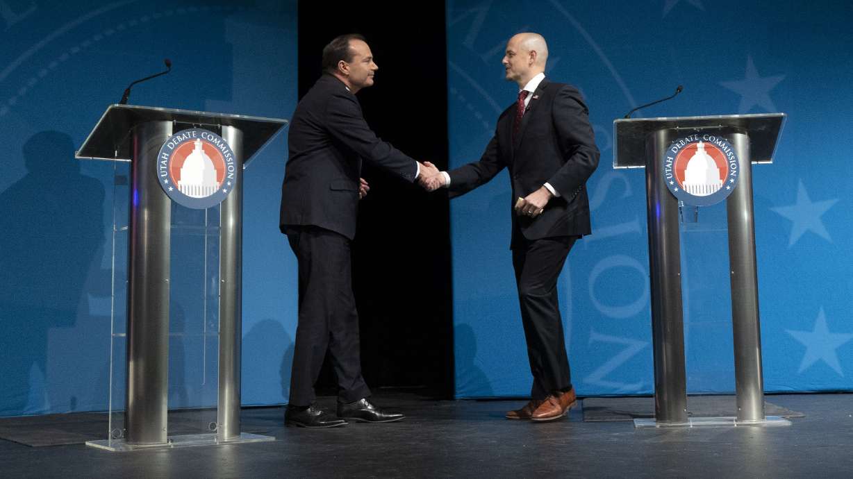 Sen. Mike Lee, R-Utah, and Evan McMullin, U.S. Senate candidate, shake hands at the debate at UVU in Orem on Oct. 17, 2022. Lee supporters outnumbered those of McMullin at their only debate in the Utah Senate race last fall.