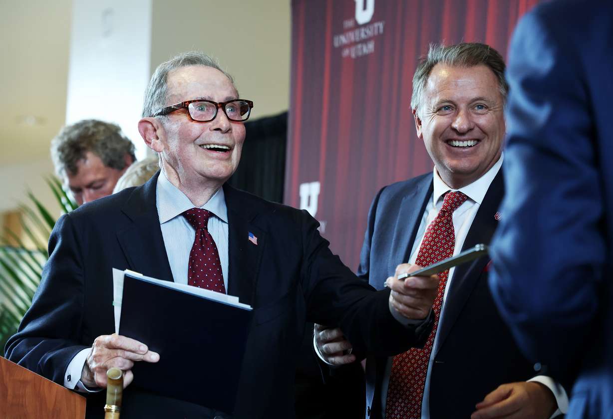 Former U.S. Ambassador John Price shows his old slide rule that he used in school to Gov. Cox after speaking as the College of Engineering at The University of Utah was renamed the John and Marcia Price College of Engineering at a ceremony in Salt Lake City on Tuesday.