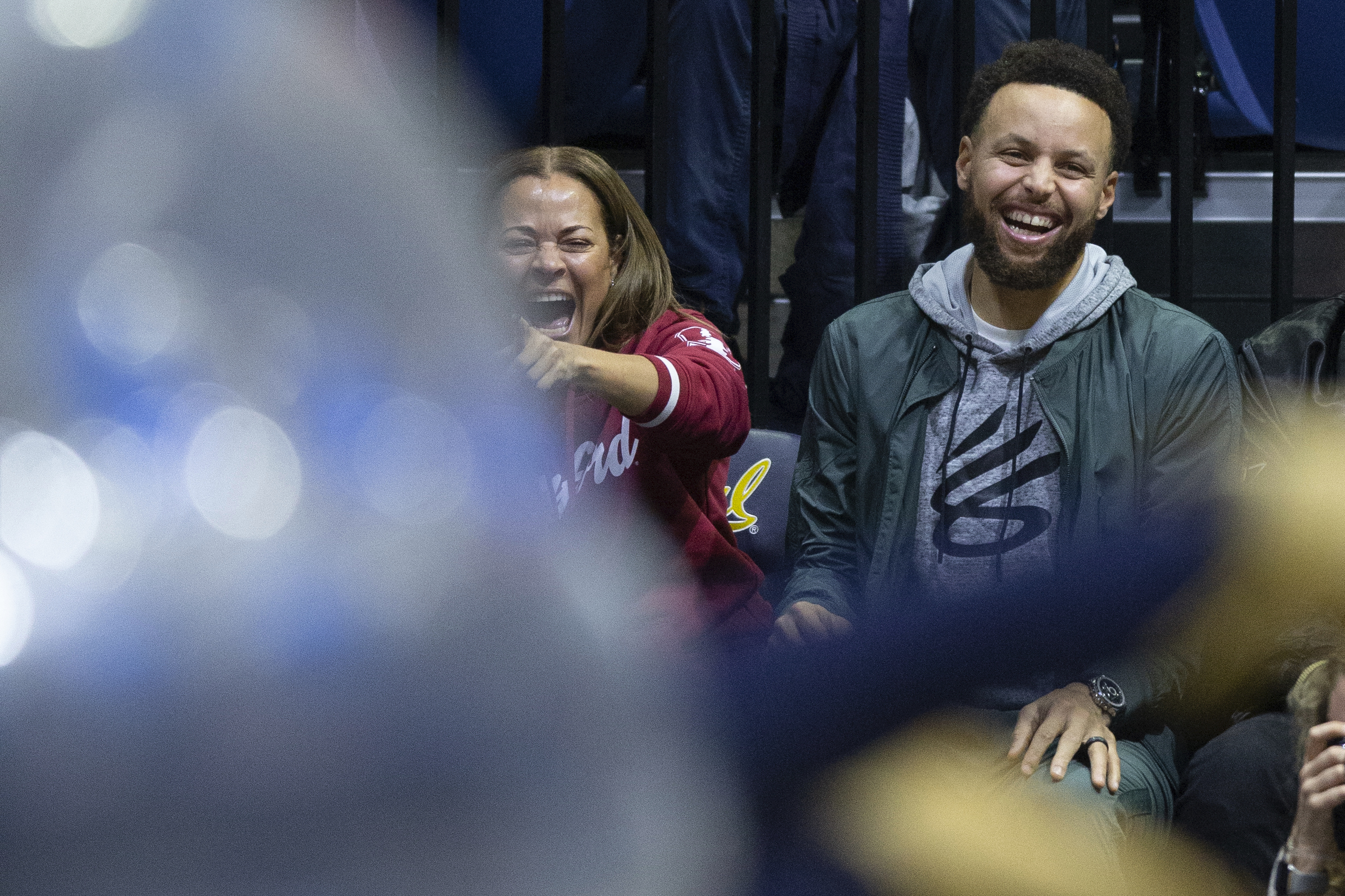 Sonya Curry, left, and her son, Golden State Warriors star Stephen Curry, laugh at a student competition during a timeout in the second half of an NCAA college basketball game between Stanford and California, Sunday, Jan. 8, 2023, in Berkeley, Calif. 