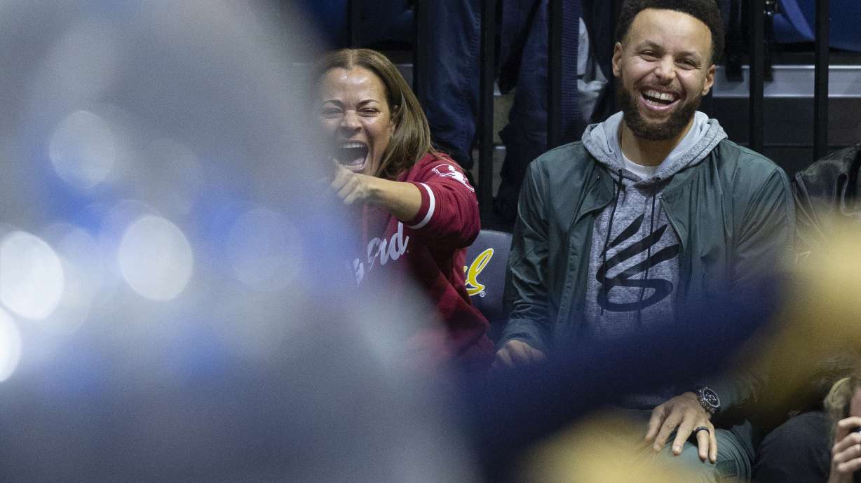 Sonya Curry, left, and her son, Golden State Warriors star Stephen Curry, laugh at a student competition during a timeout in the second half of an NCAA college basketball game between Stanford and California, Sunday, Jan. 8, 2023, in Berkeley, Calif.